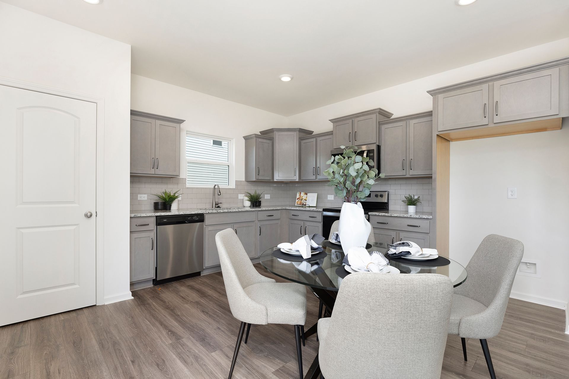 A kitchen with a table and chairs in it
