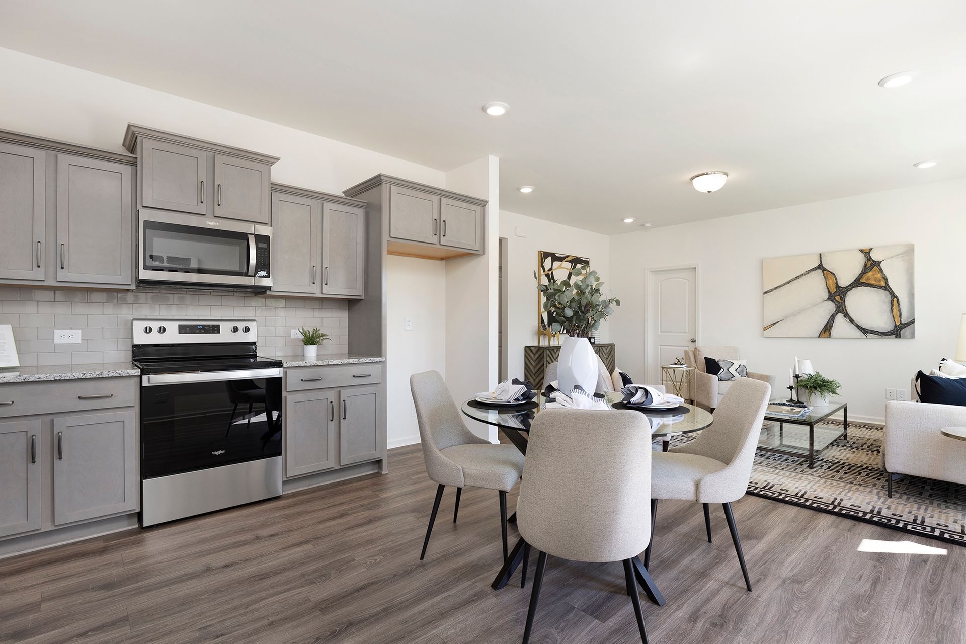 A kitchen with a table and chairs in it