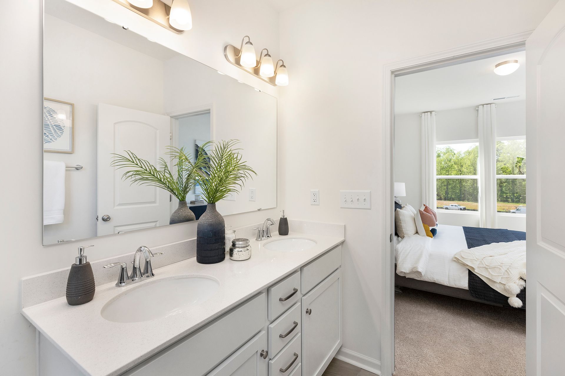 A bathroom with a double sink and a large mirror.