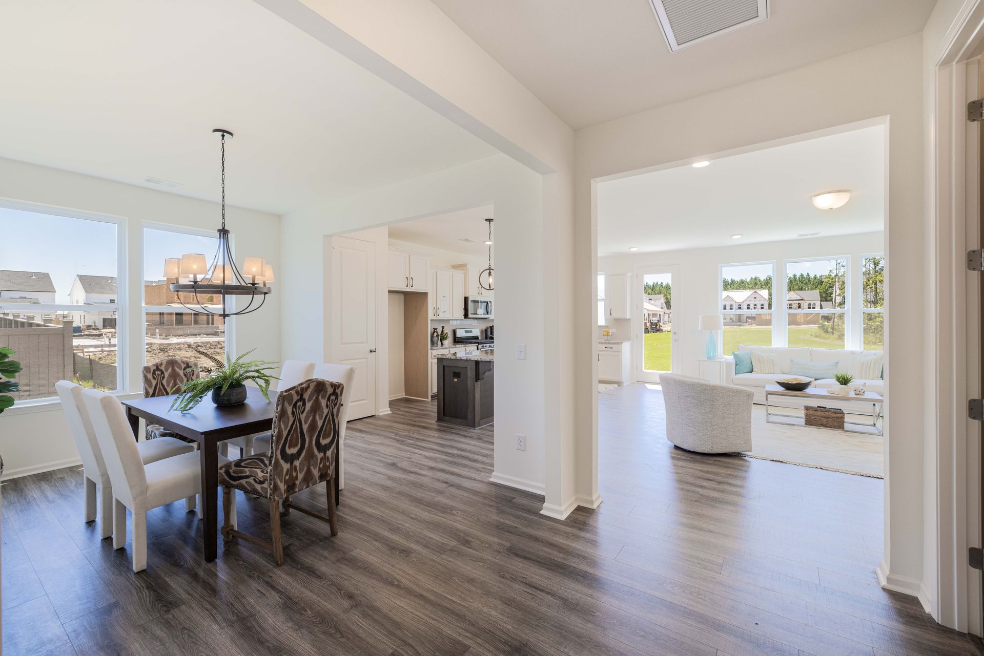 There is a dining room table and chairs in the middle of the room.