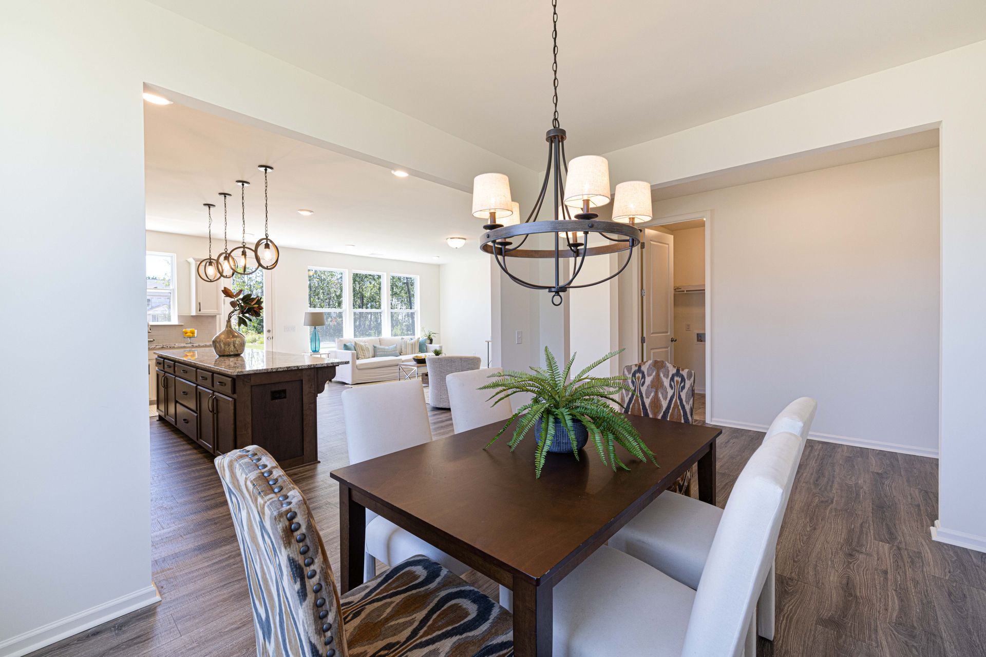 A dining room with a table and chairs and a chandelier.