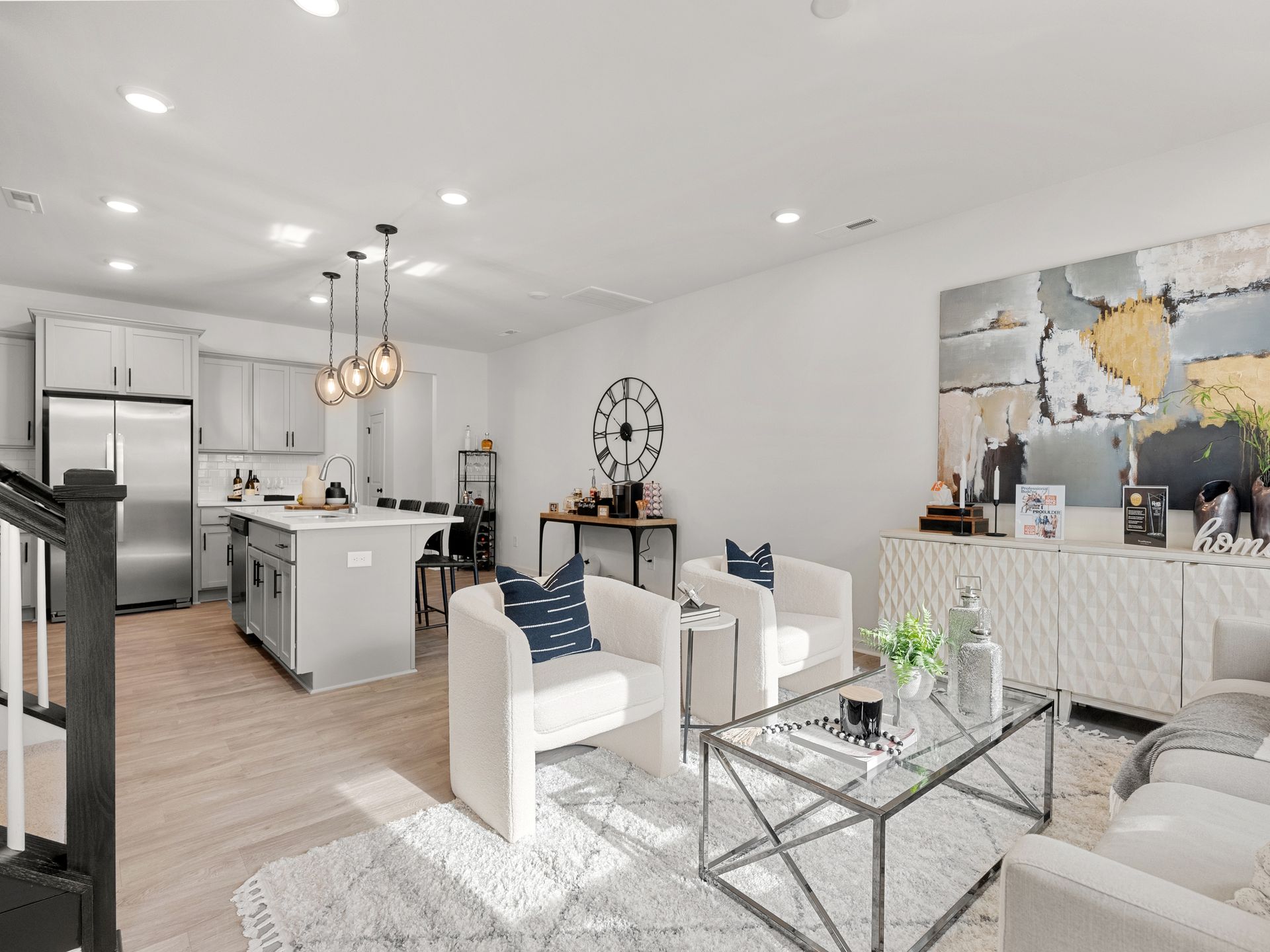 A living room filled with furniture and a clock on the wall.
