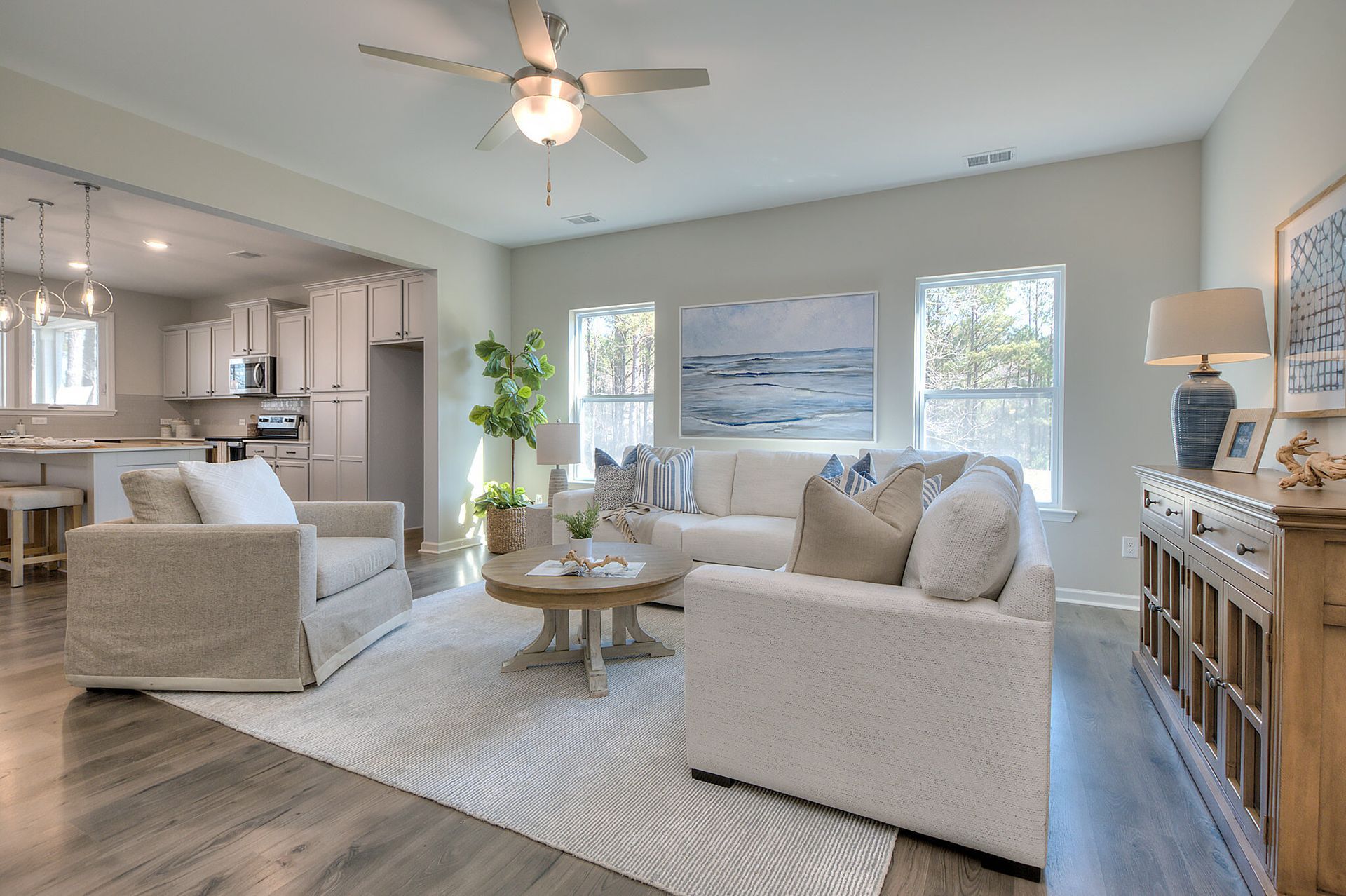 A living room filled with furniture and a ceiling fan.