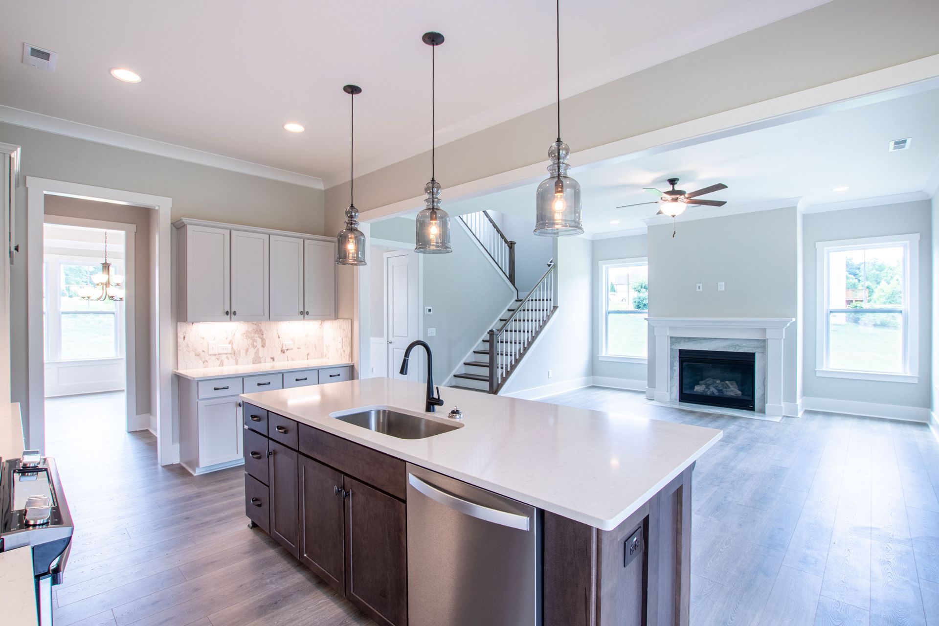 A kitchen with stainless steel appliances and a large island in the middle of the room.