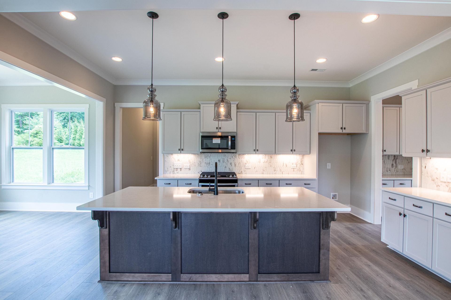 There is a large island in the middle of the kitchen.