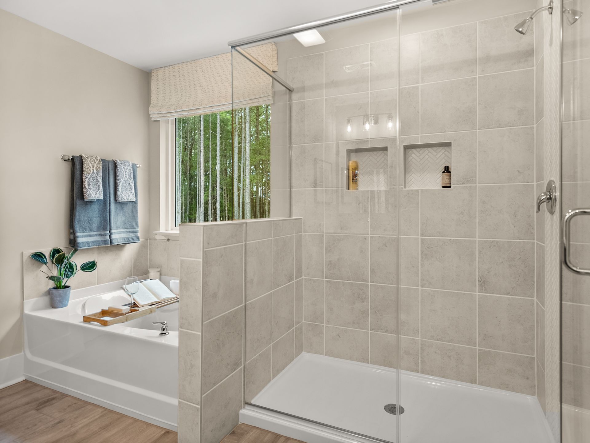 A bathroom with a bathtub and a walk in shower.