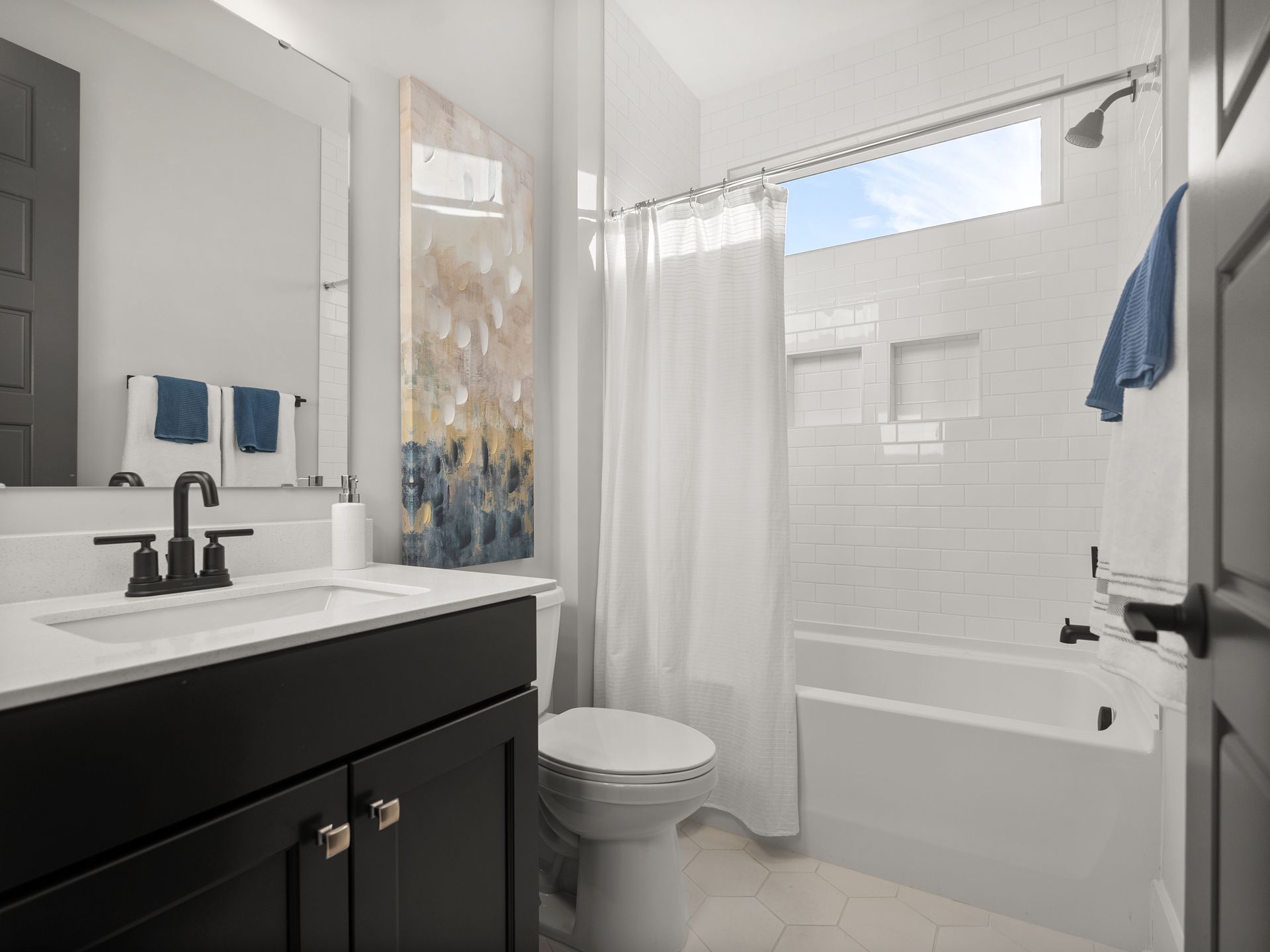 a bathroom with a toilet , sink , and bathtub .