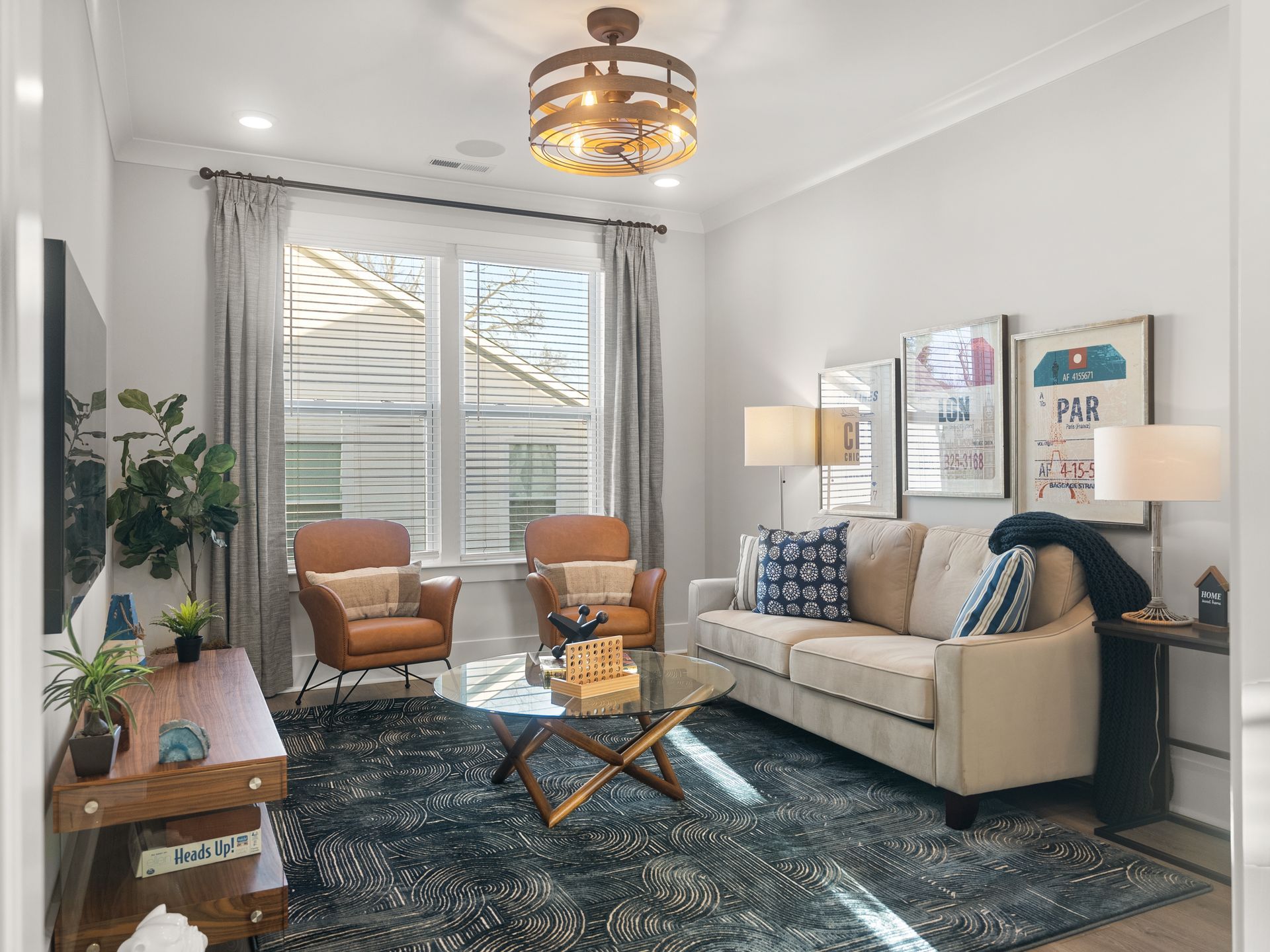 A living room with a couch , chairs , coffee table and television.