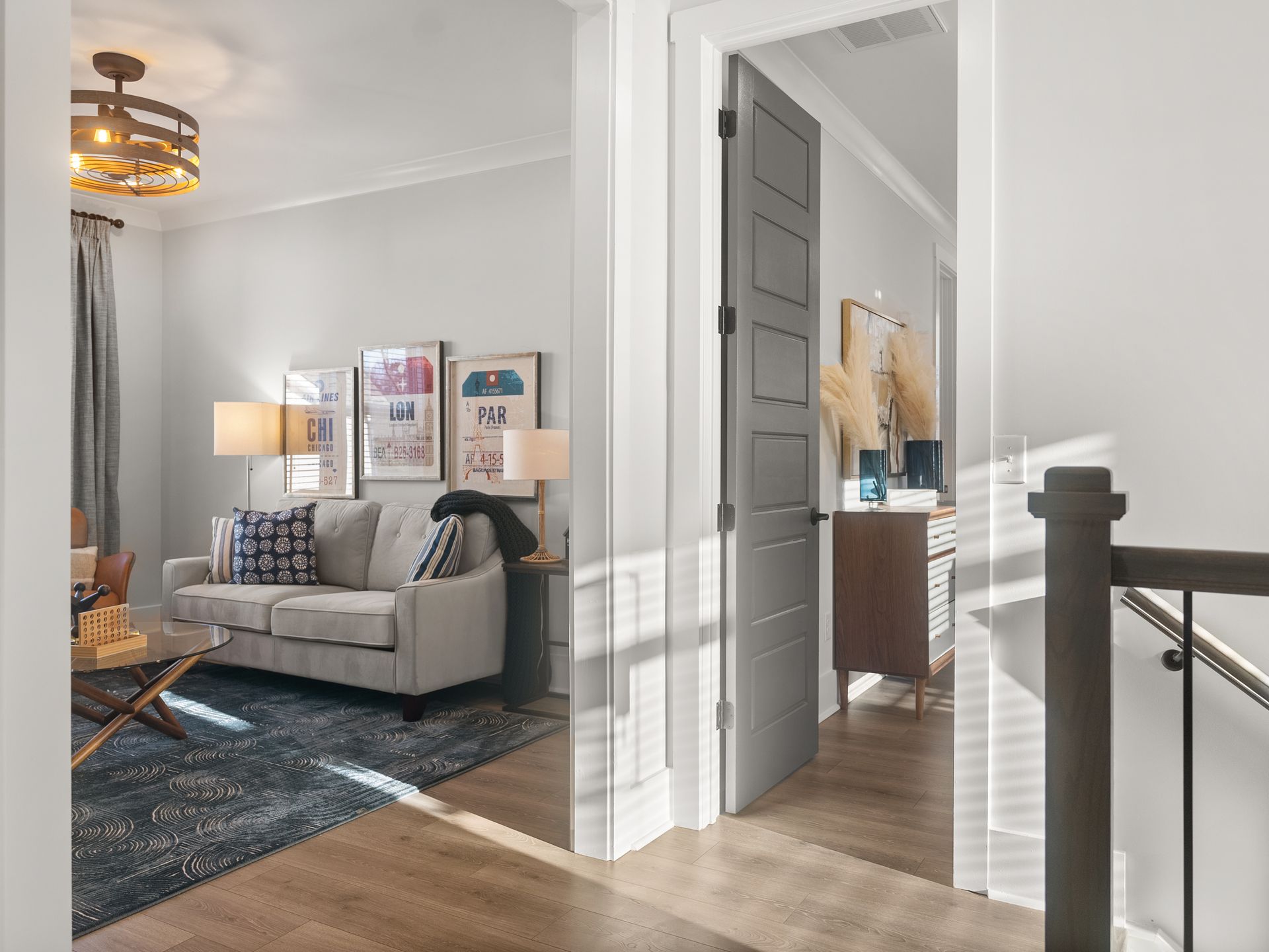 A living room with a couch and stairs leading to the second floor.