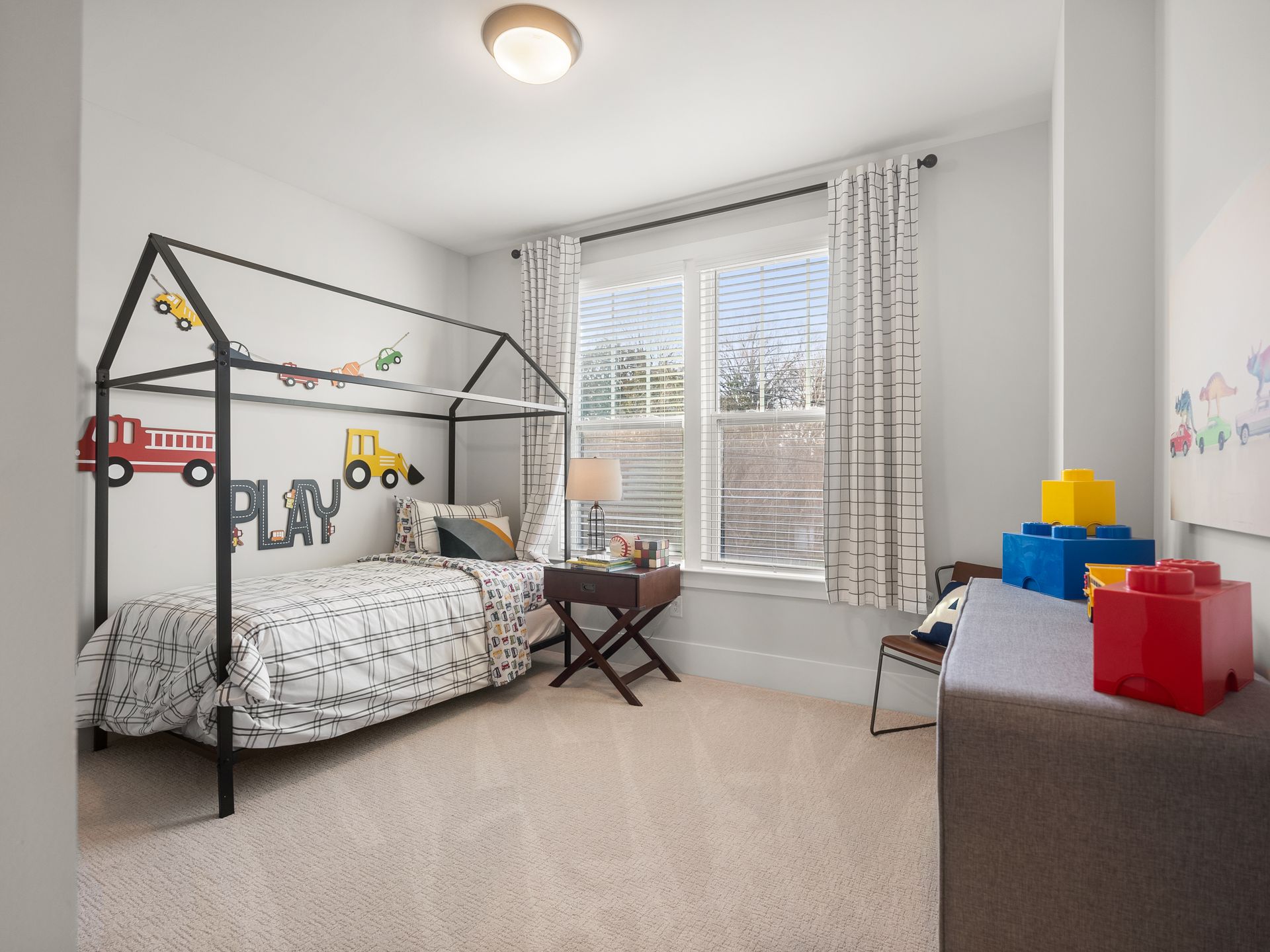 A bedroom with a bed , desk , and window.