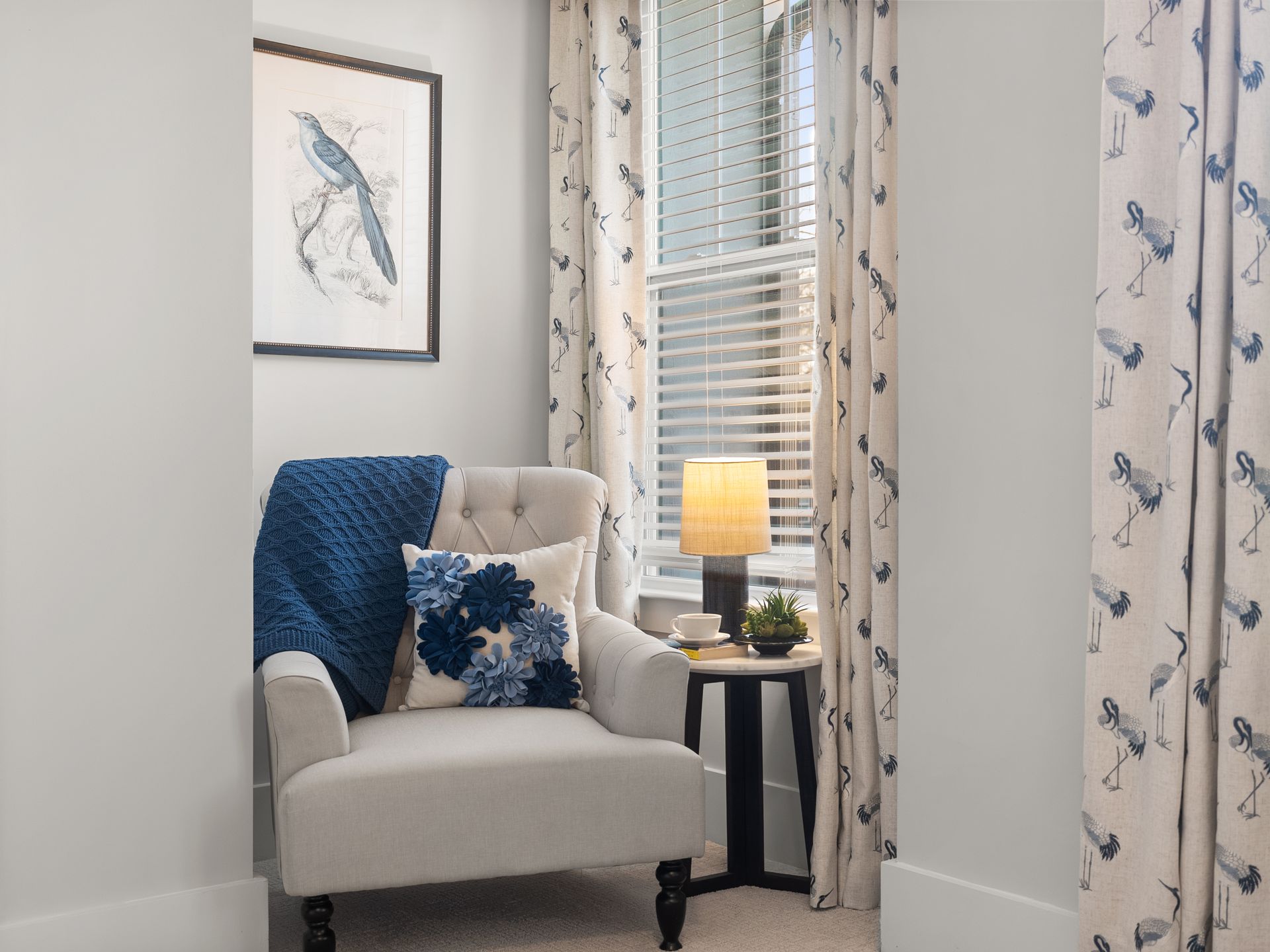 There is a chair in the corner of the room next to a window.