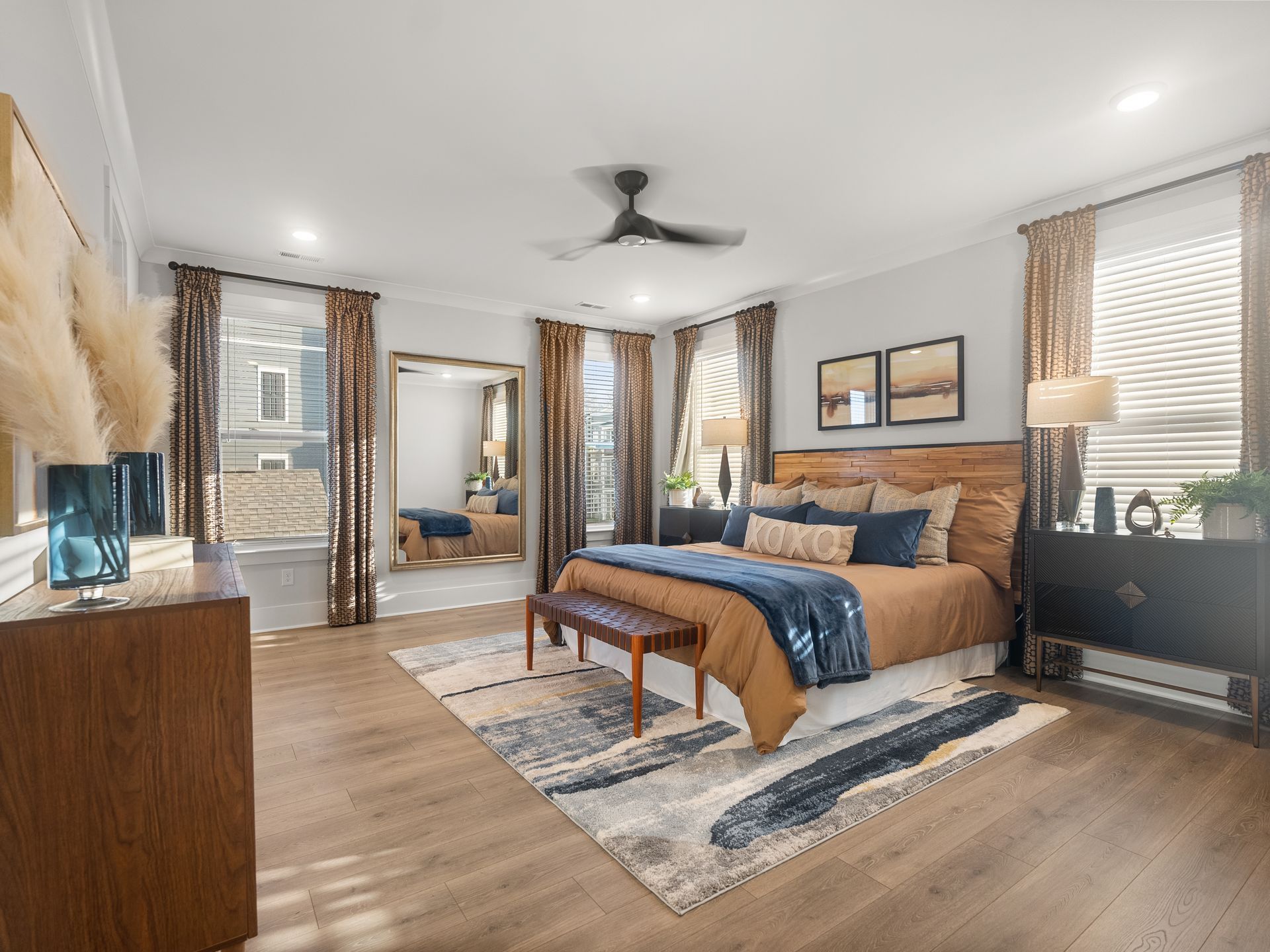 a bedroom with a large bed and a ceiling fan .