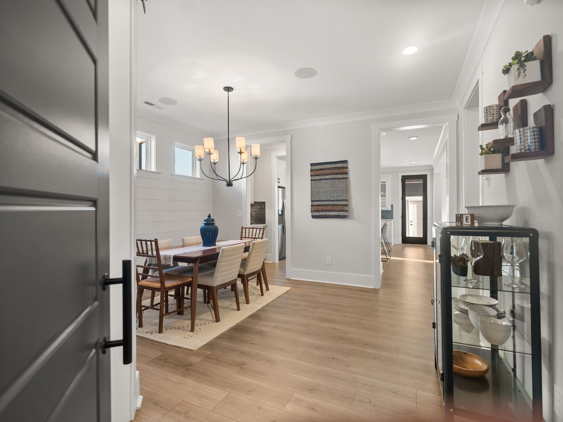 a dining room with a table and chairs and a chandelier .
