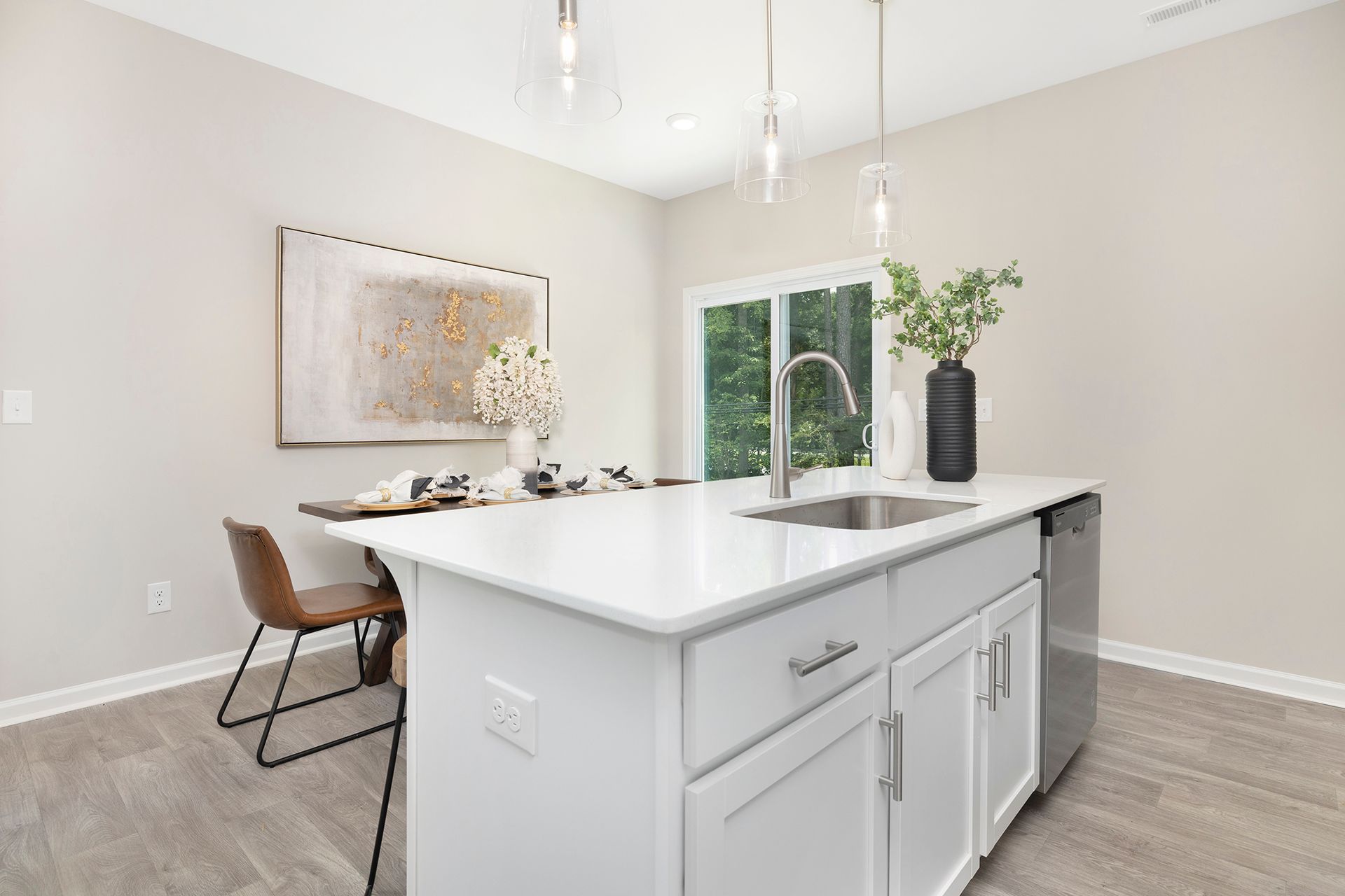A kitchen with a large island and a sink.