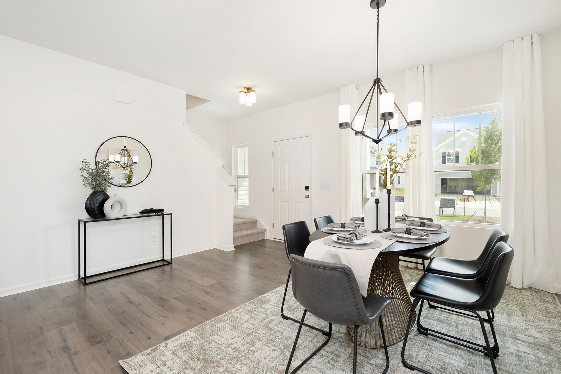 A dining room with a table and chairs and a chandelier.
