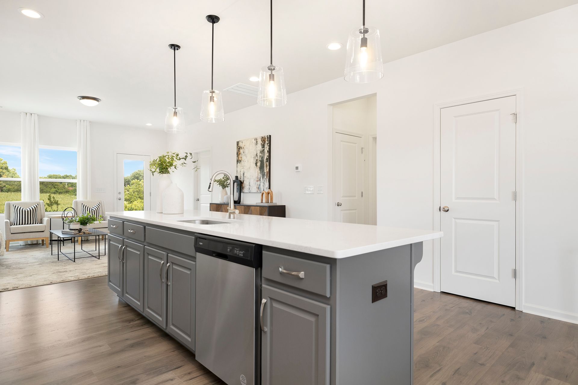A kitchen with a large island and stainless steel appliances.