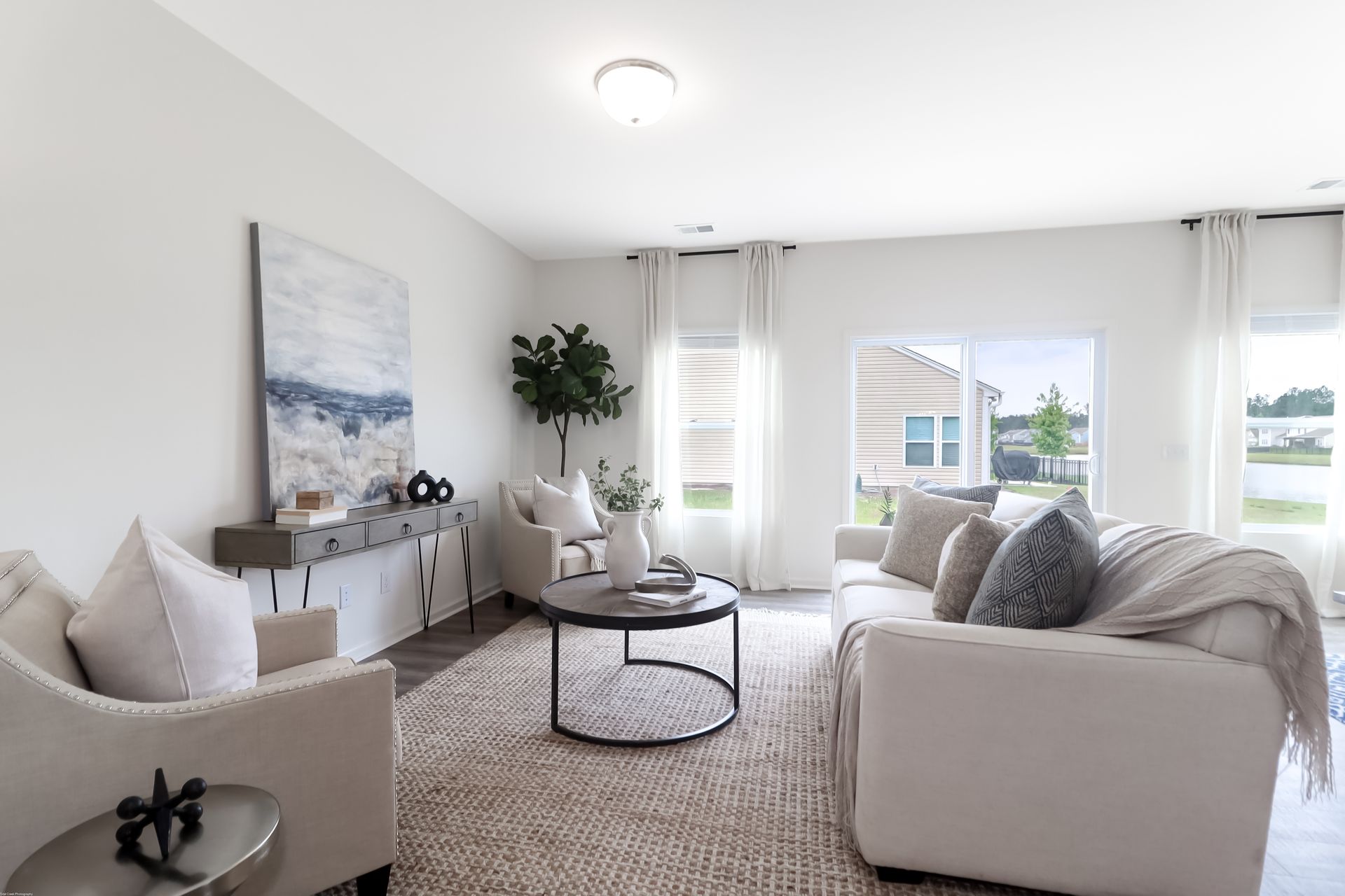 A living room with a couch , chairs , and a coffee table.