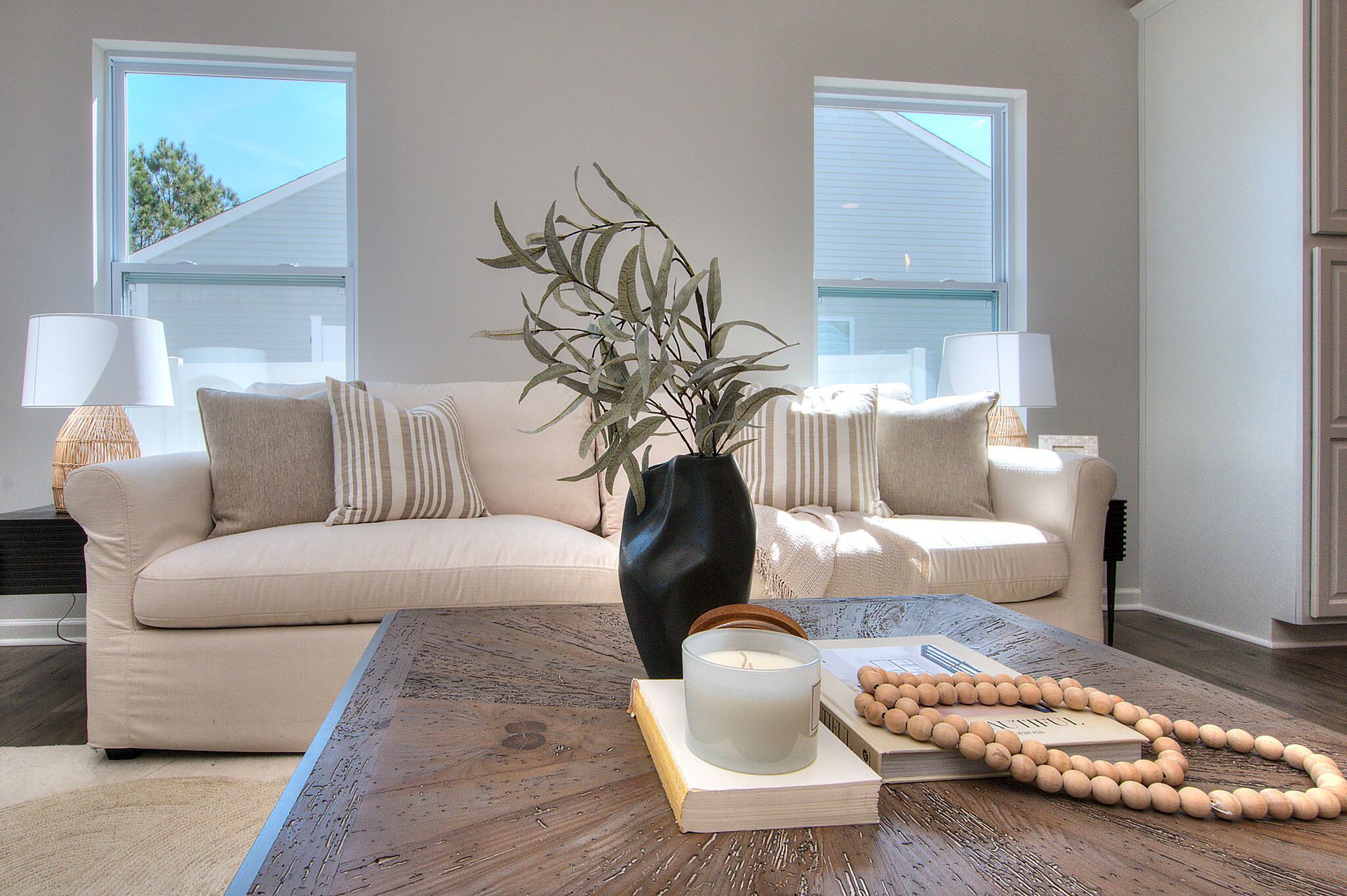 A living room with two couches and a coffee table with a candle on it.