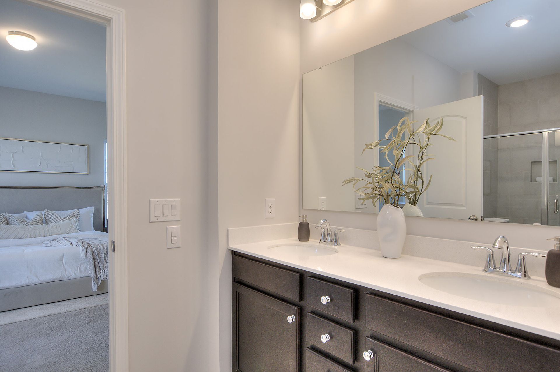 A bathroom with two sinks and a large mirror.