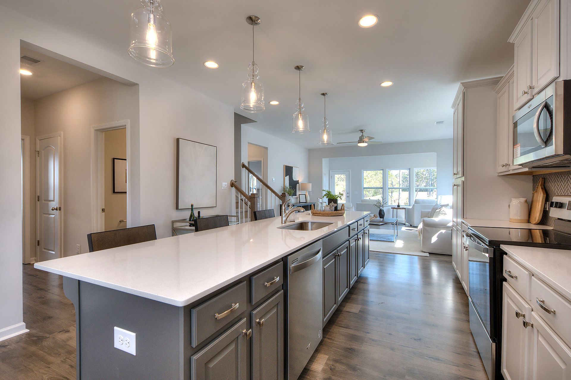 A kitchen with a large island and stainless steel appliances.