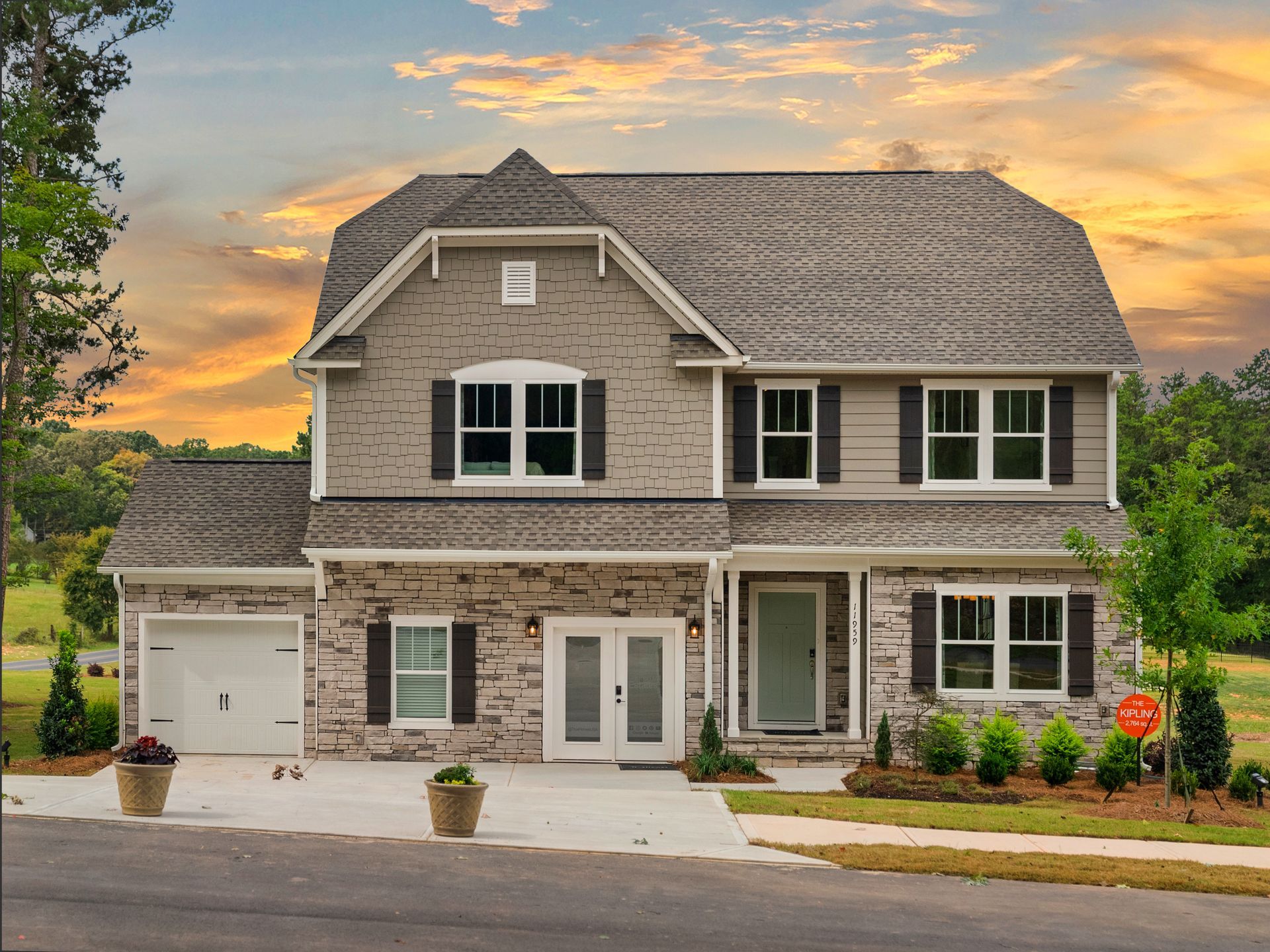 A large house with a lot of windows and a garage is for sale.