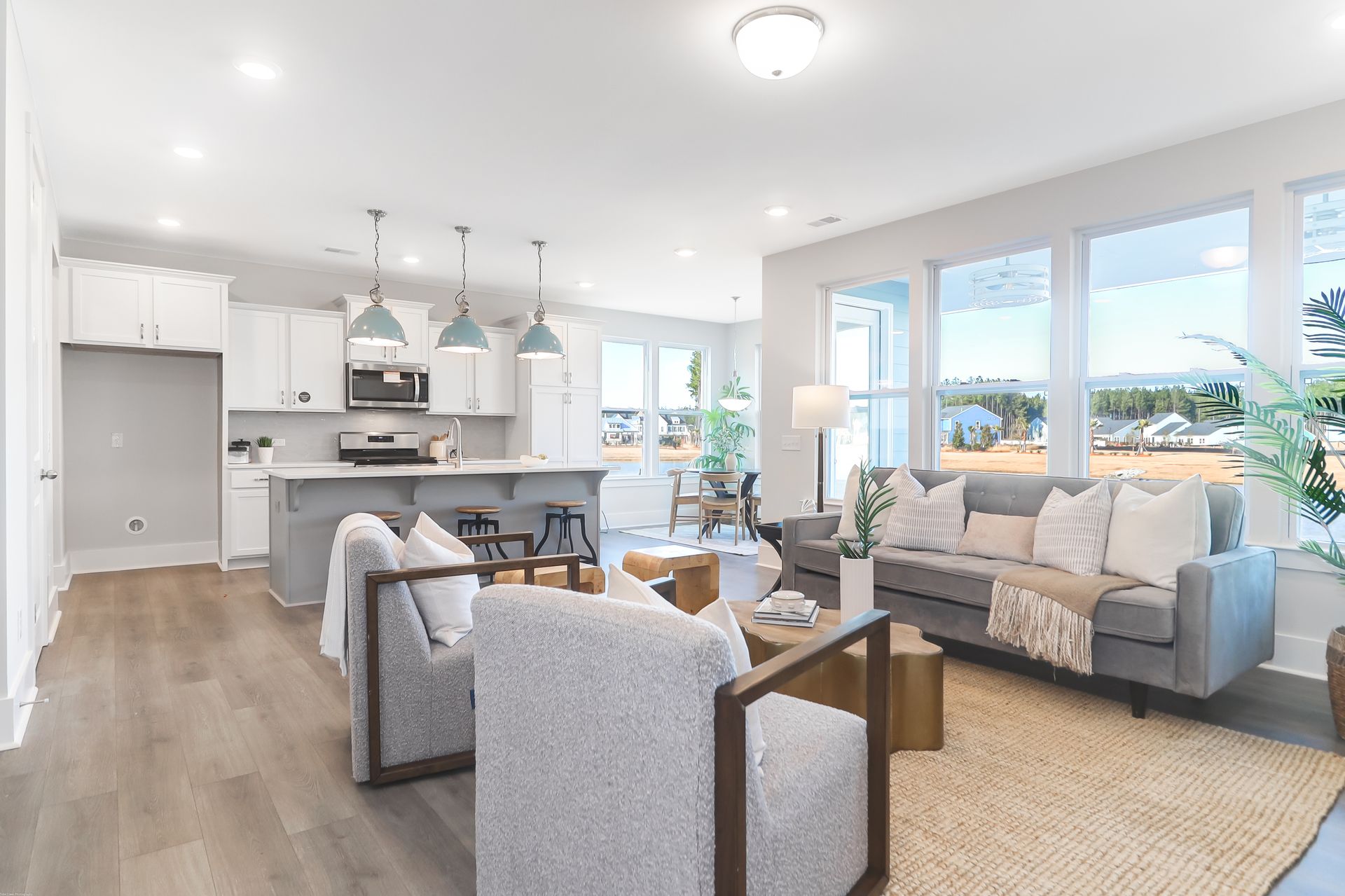 A living room with a couch , chairs , and a coffee table.