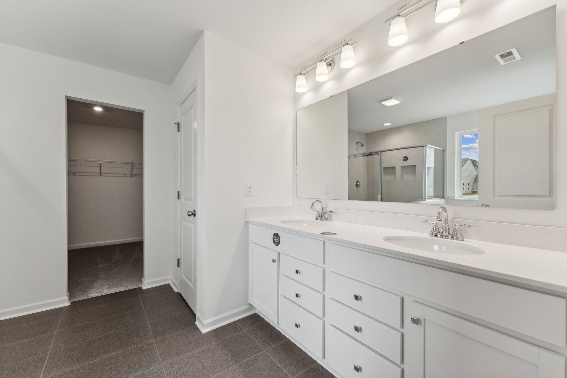 A bathroom with two sinks and a large mirror.