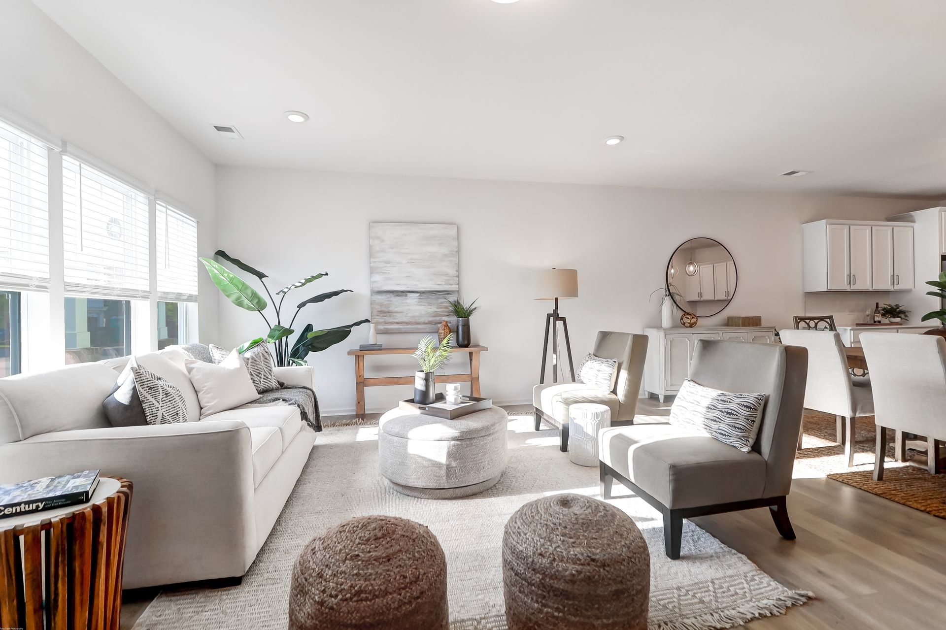 A living room with a couch , chairs , and a coffee table.