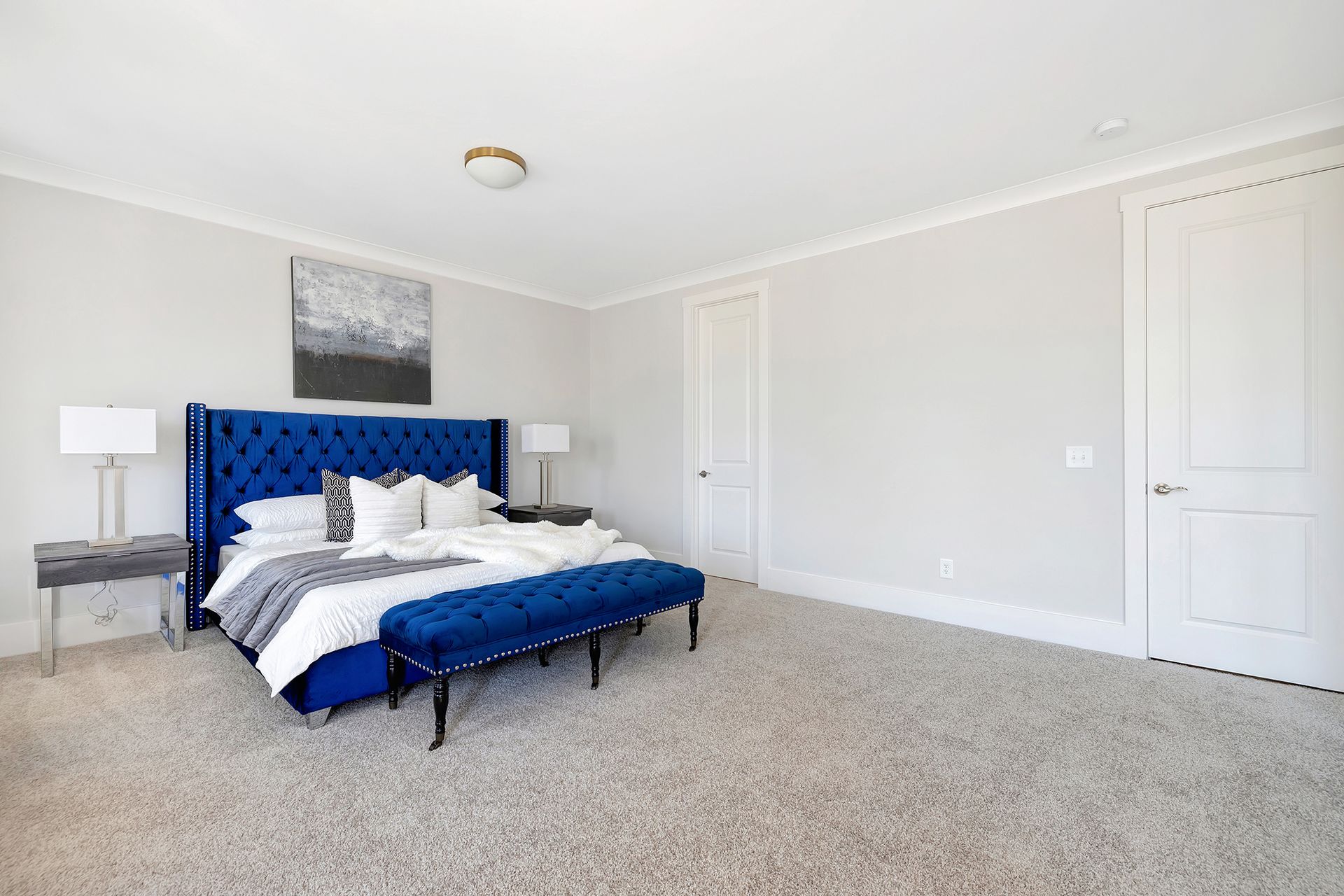 A bedroom with a large bed and a blue headboard.