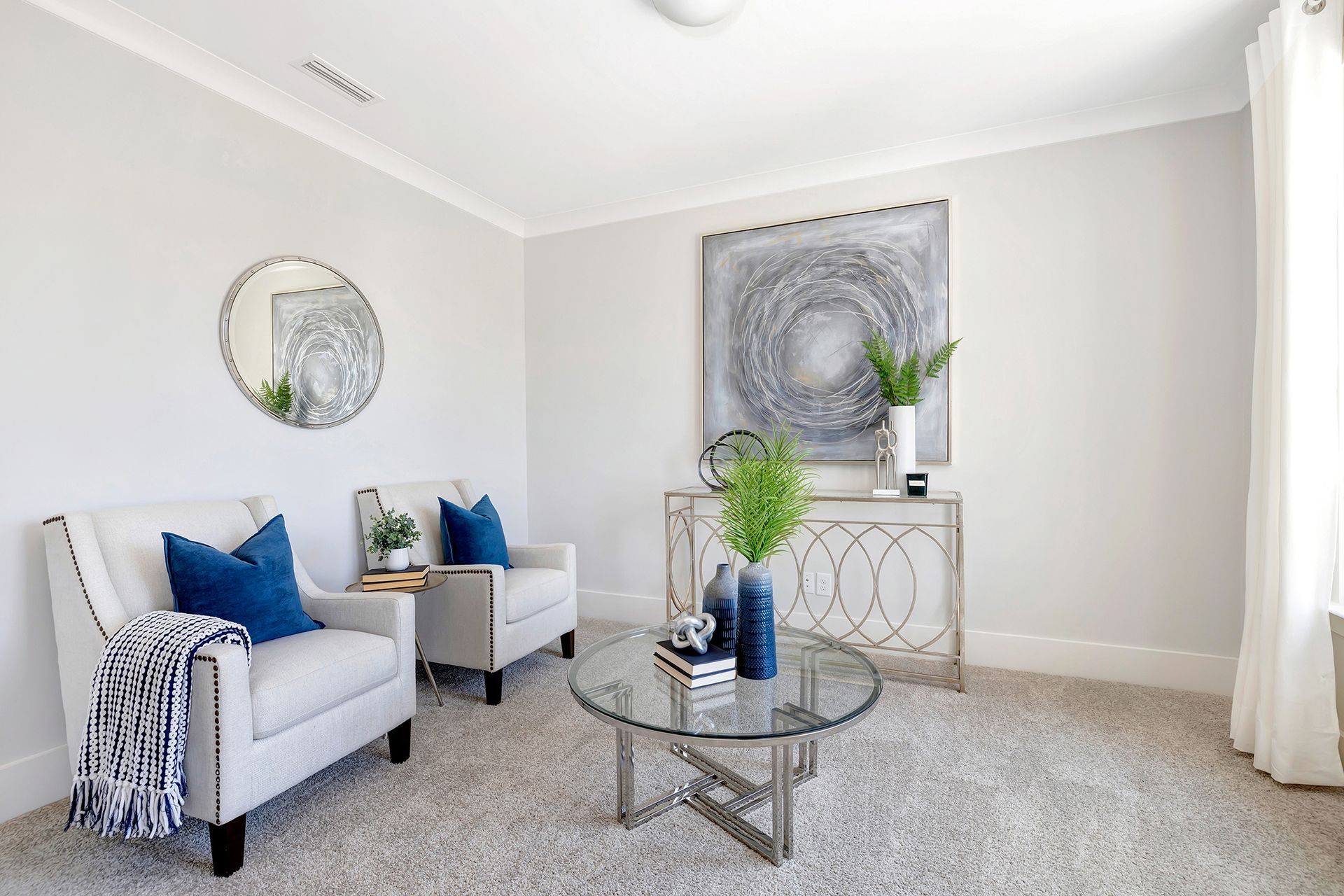 A living room with two chairs and a coffee table.