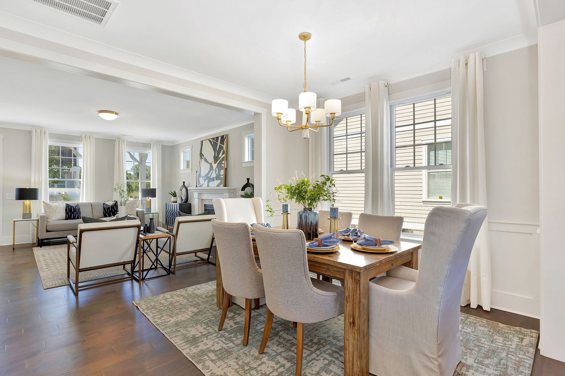 There is a dining room table and chairs in the middle of the room.