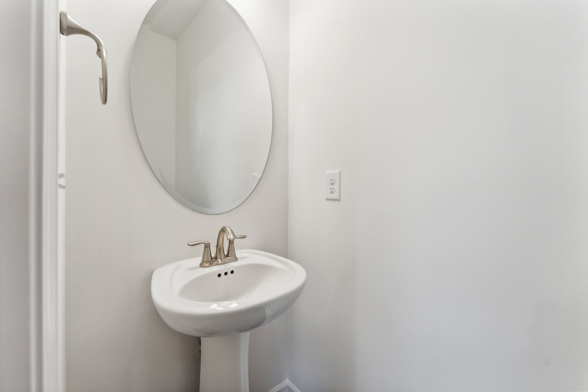 A bathroom with a sink , mirror and shower.