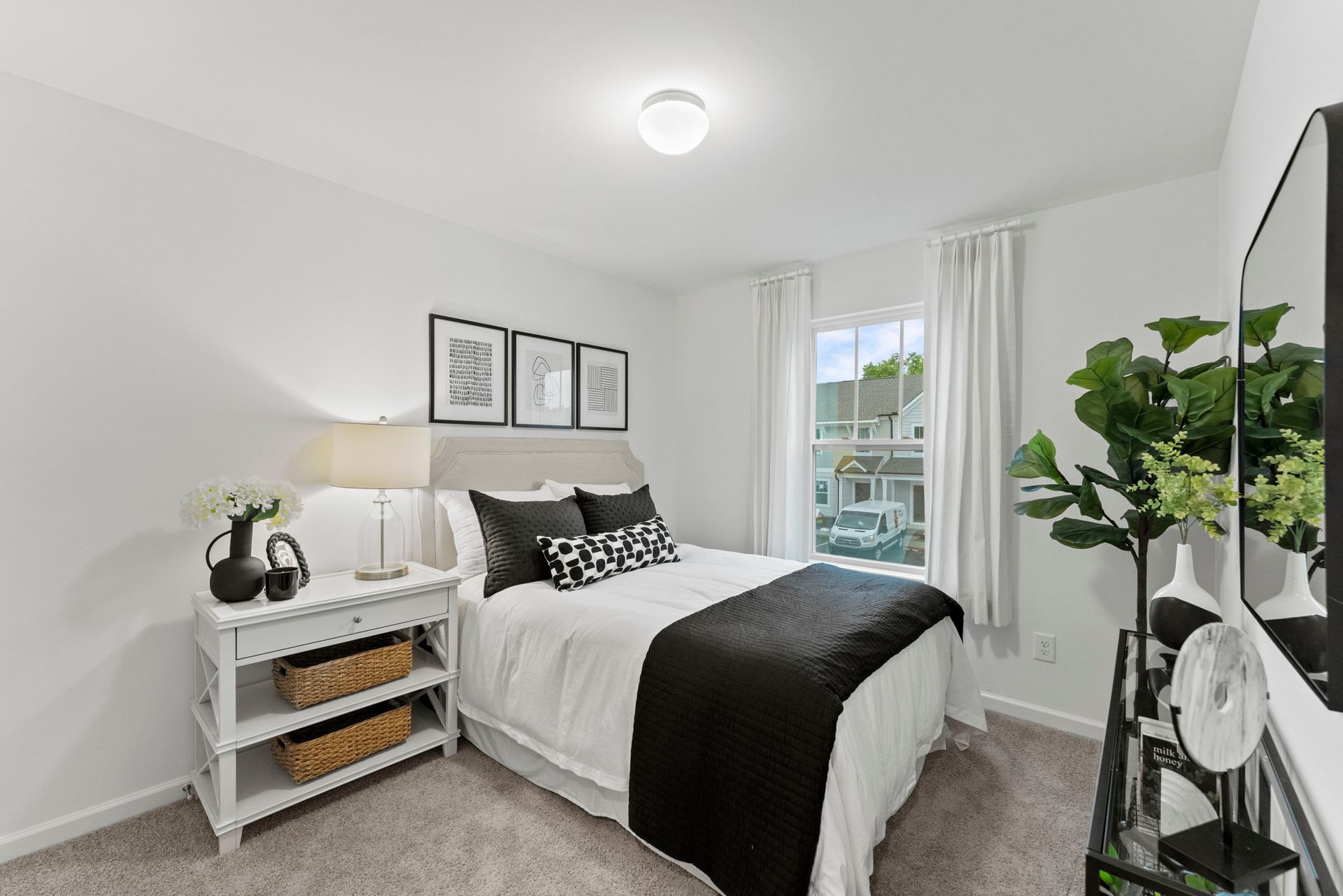 A bedroom with a bed , nightstand , and television.