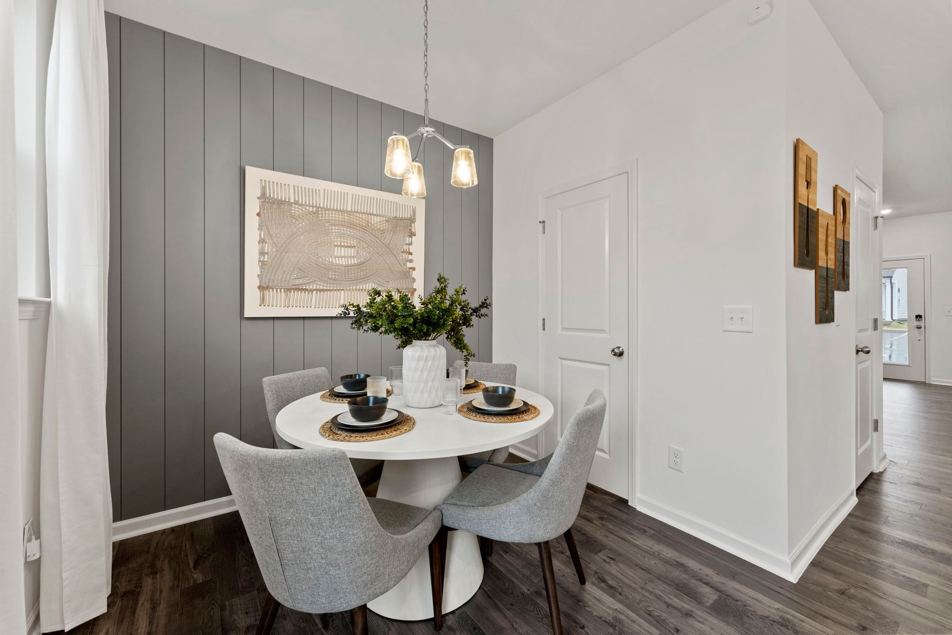 A dining room with a round table and chairs.