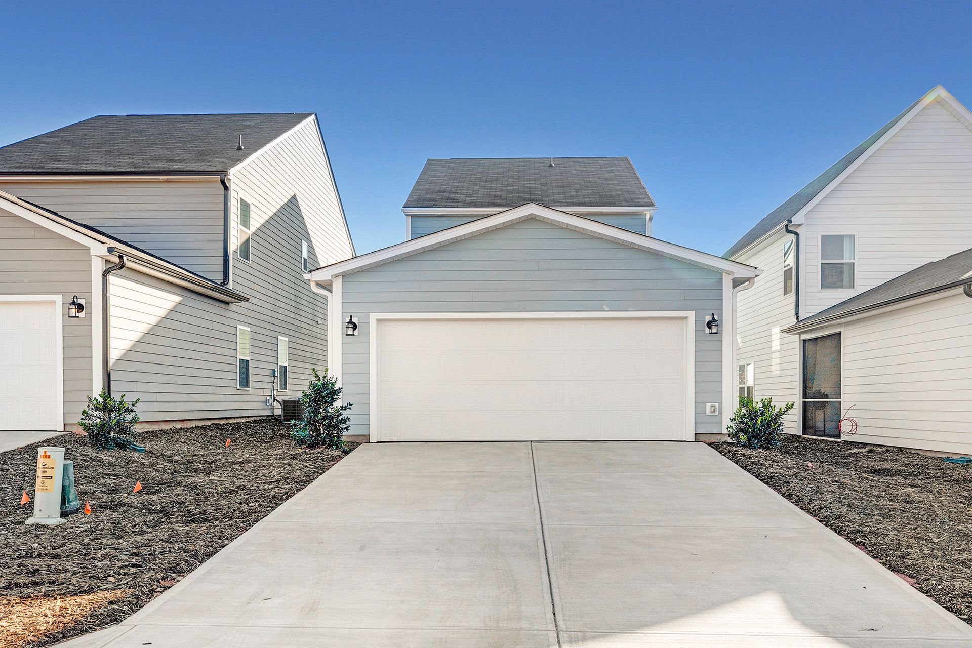 A house with a garage and a driveway in front of it