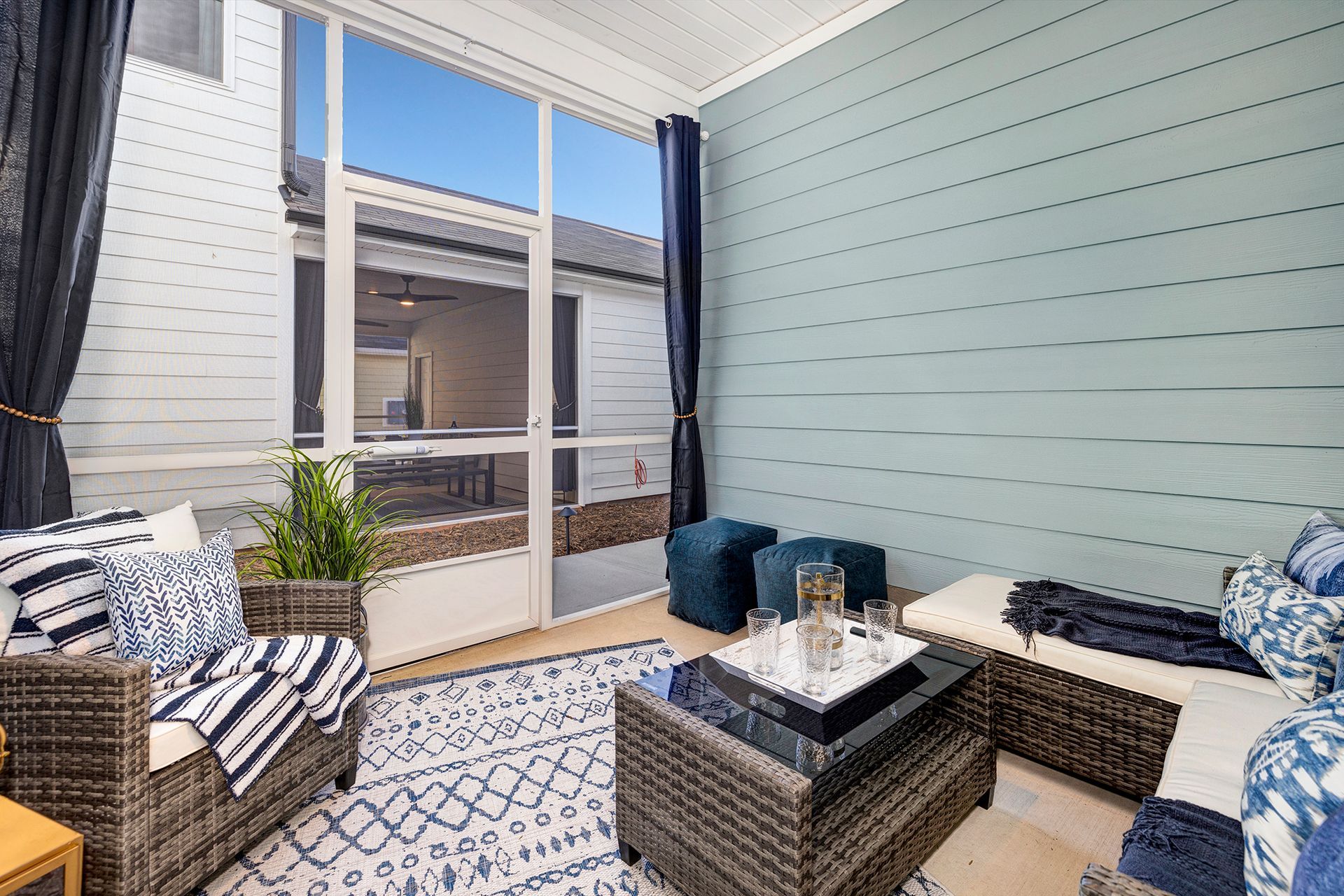 A living room with a lot of furniture and a large window.