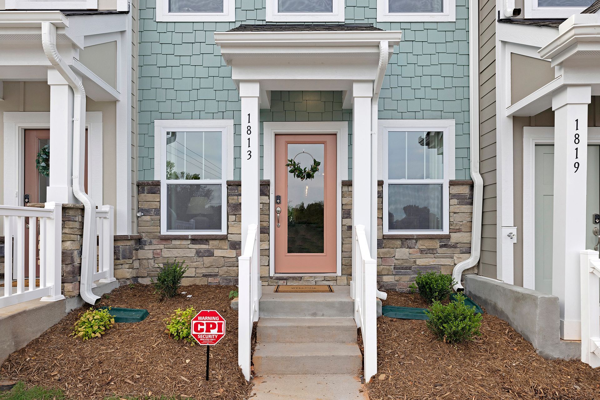 The front of a house with a stop sign in front of it.