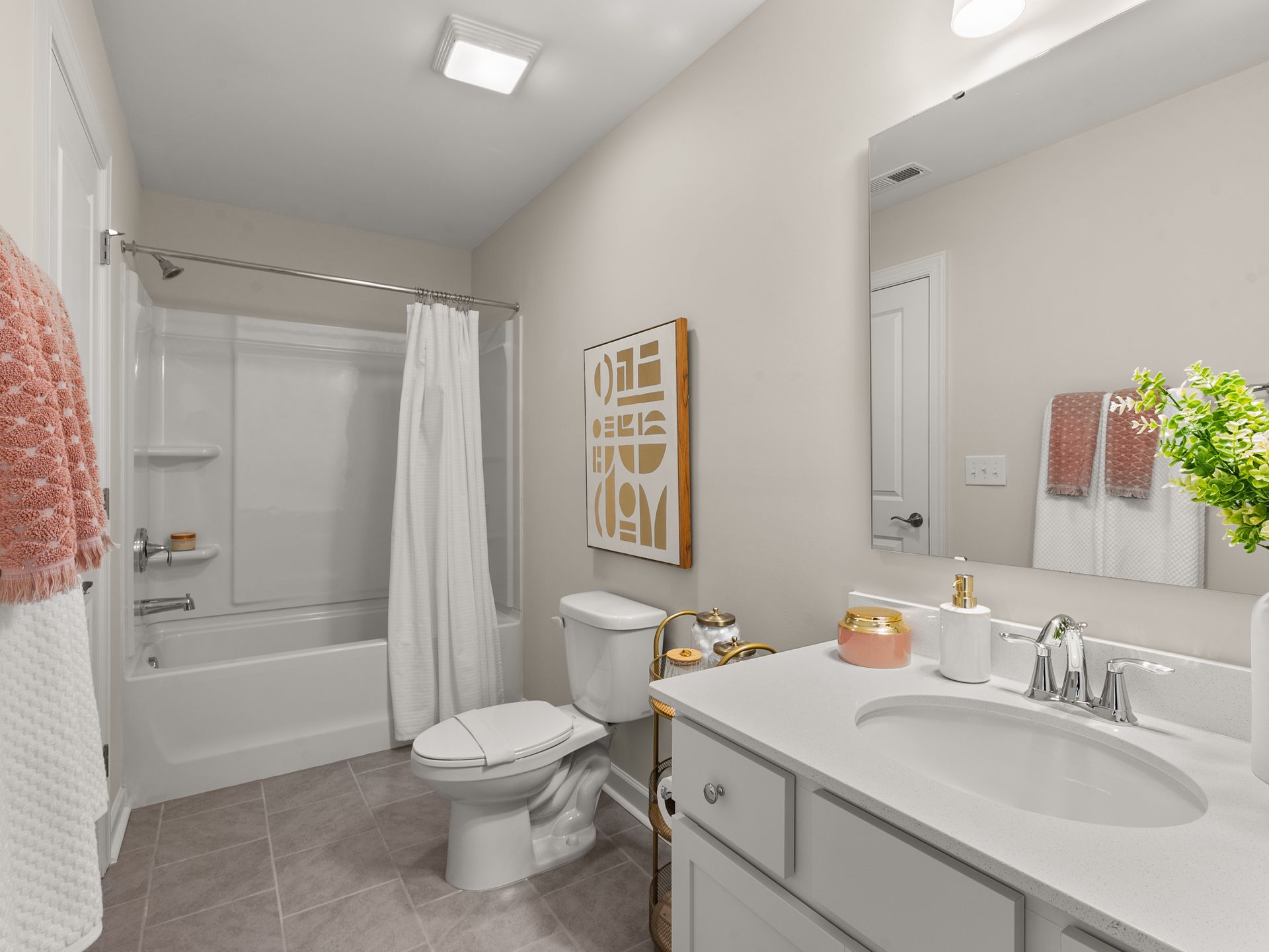 A bathroom with a sink , toilet , bathtub and mirror.