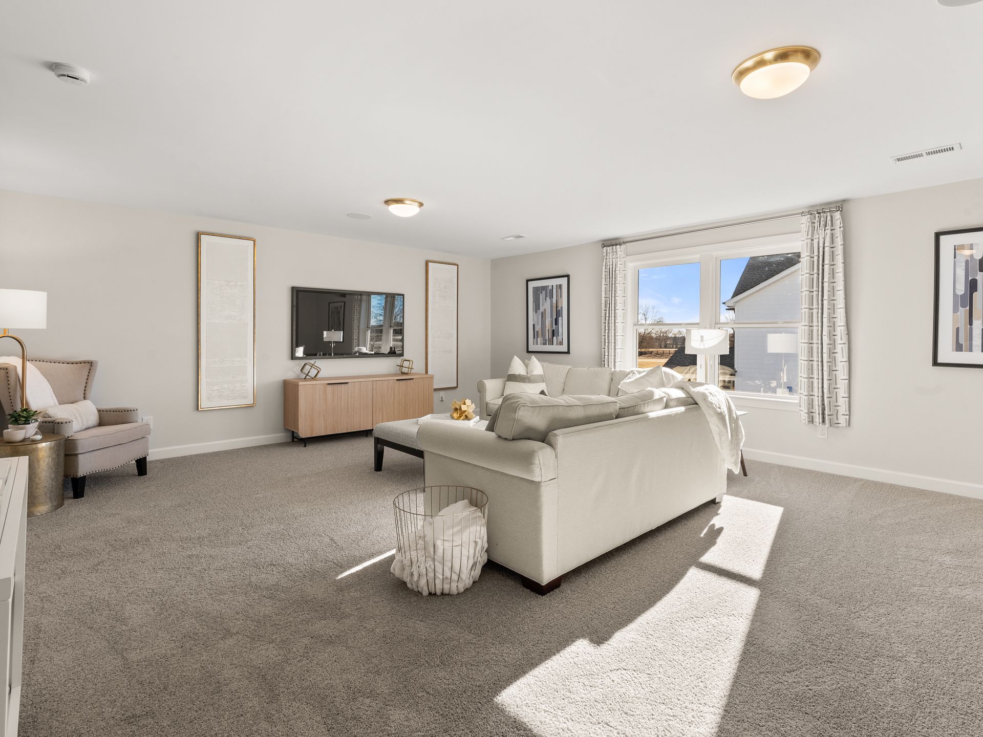 A living room with a couch , chair , and television.