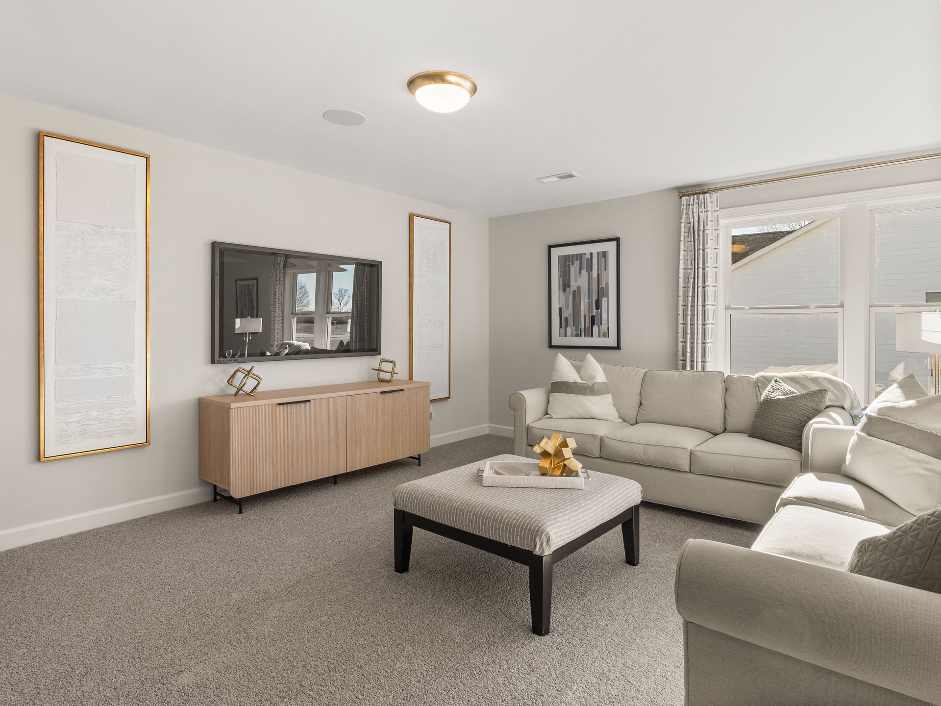 A living room with a couch , coffee table , and television.