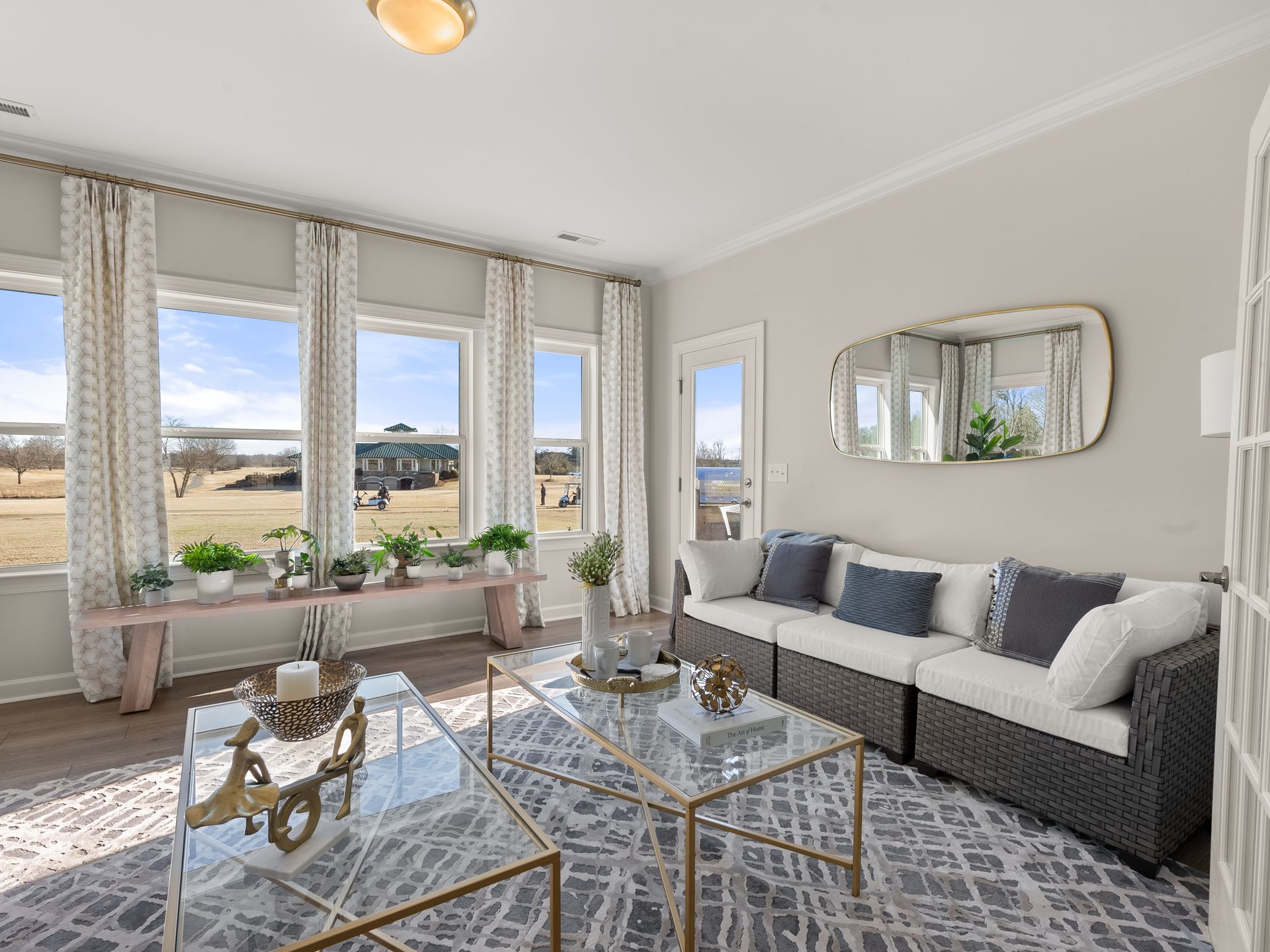 A living room with a couch , coffee table , and mirror.