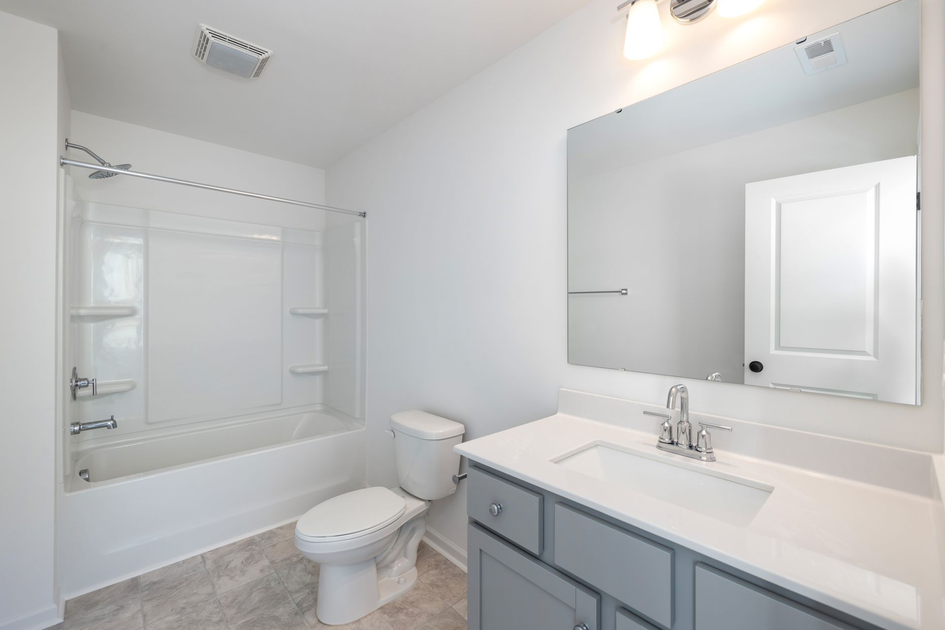 A bathroom with a toilet , sink , and bathtub.