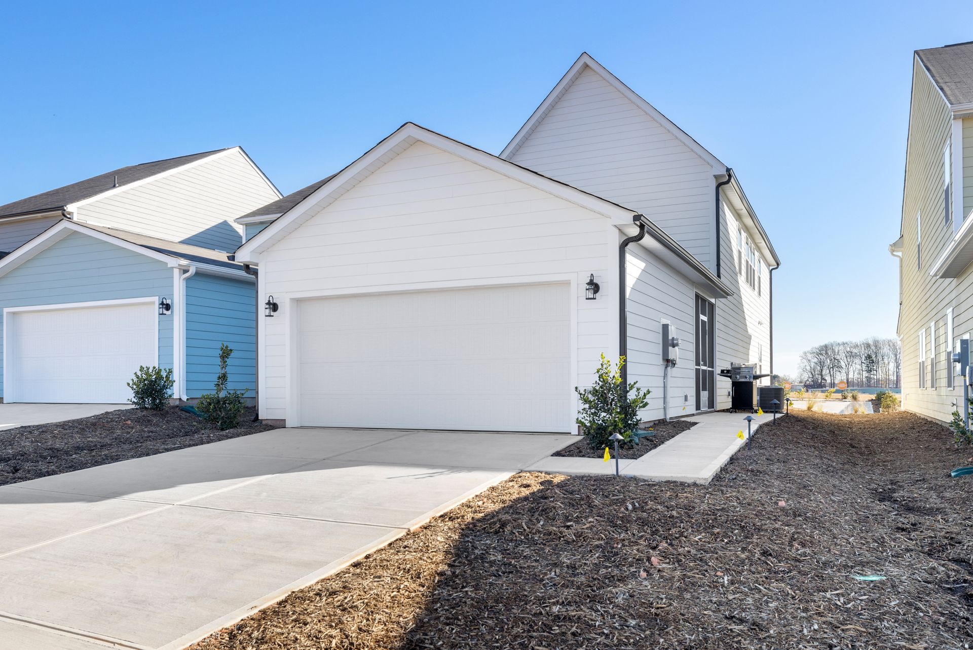 A white house with a blue house in the background