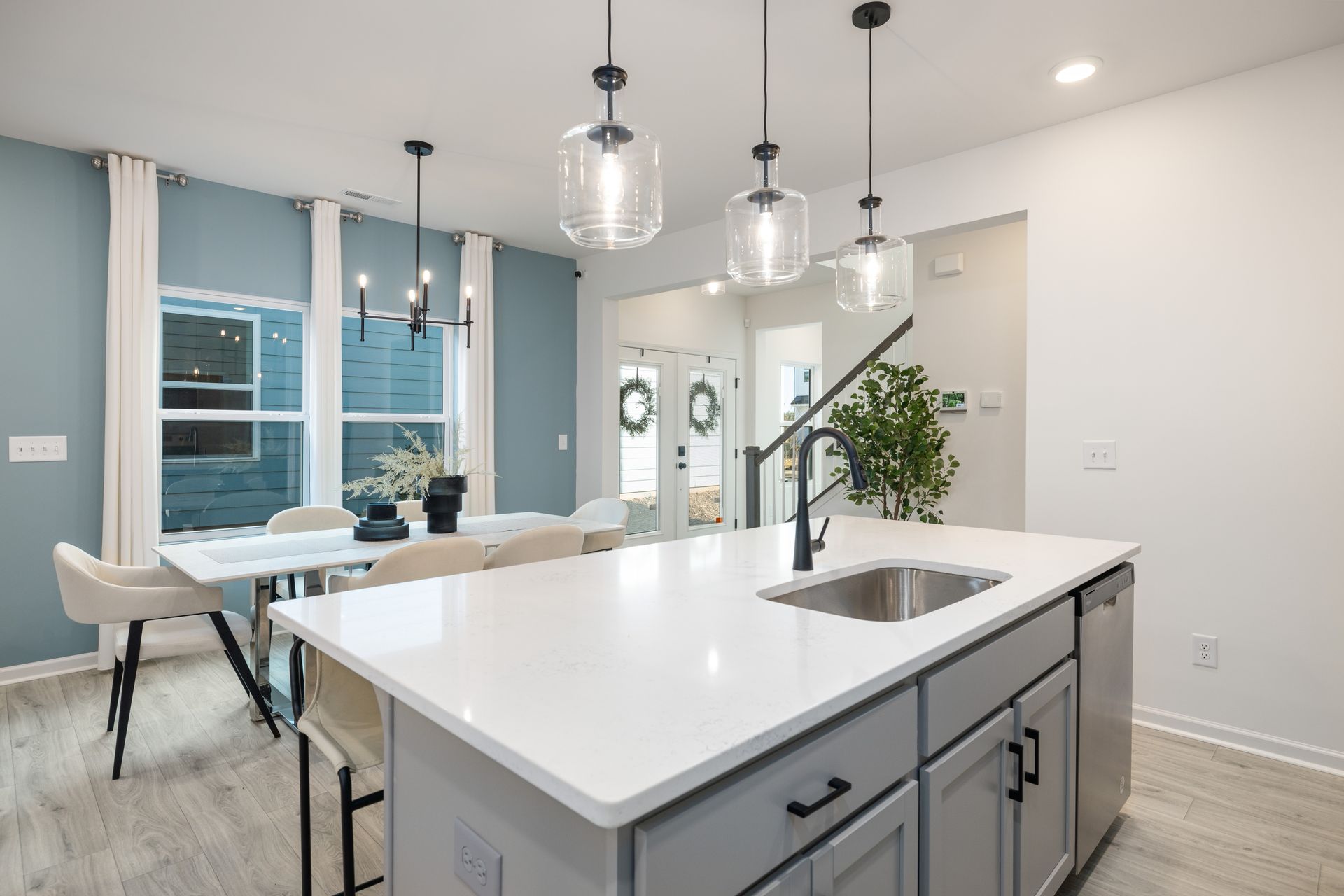 A kitchen with a large island and a sink.