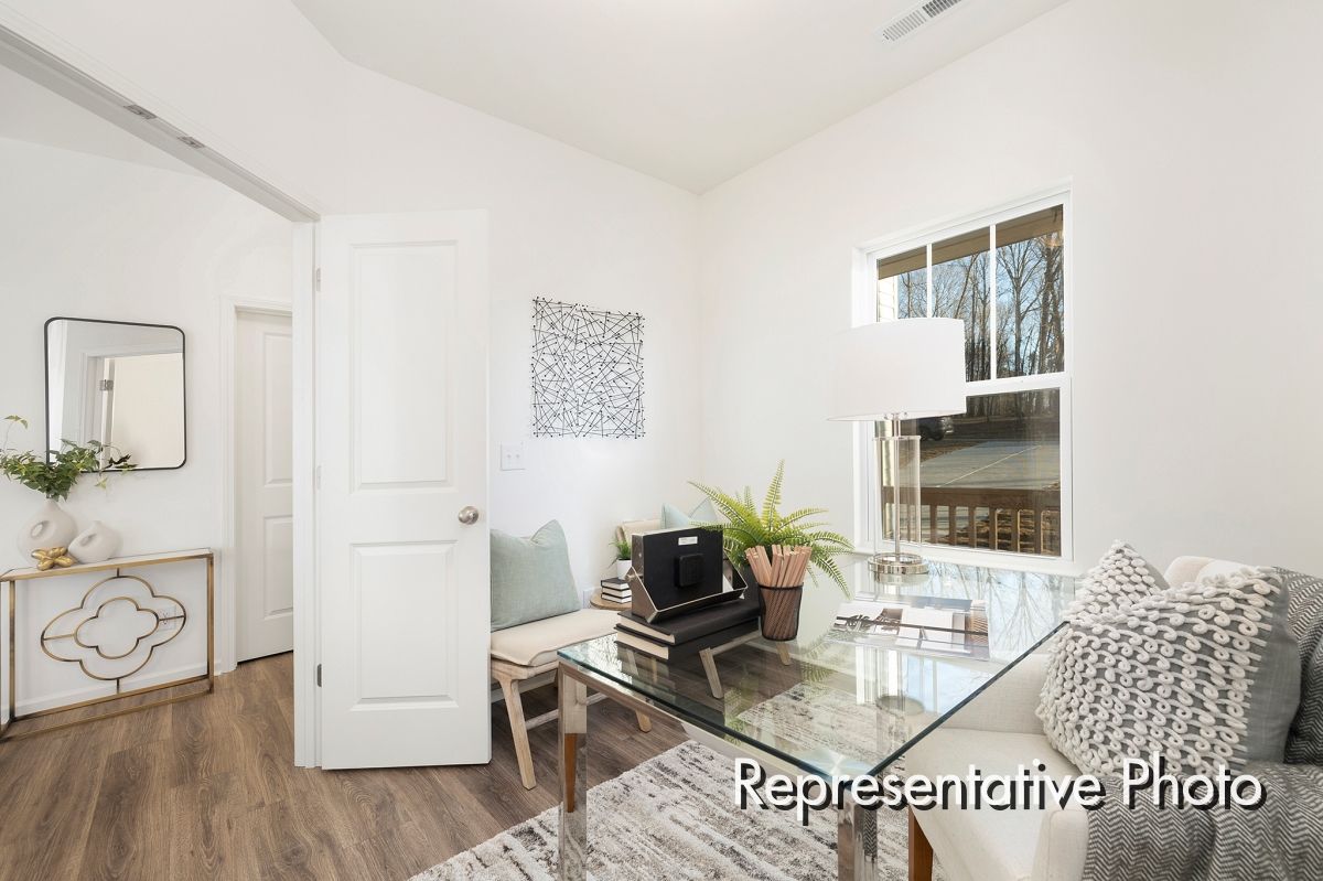 A living room with a glass table and a couch.