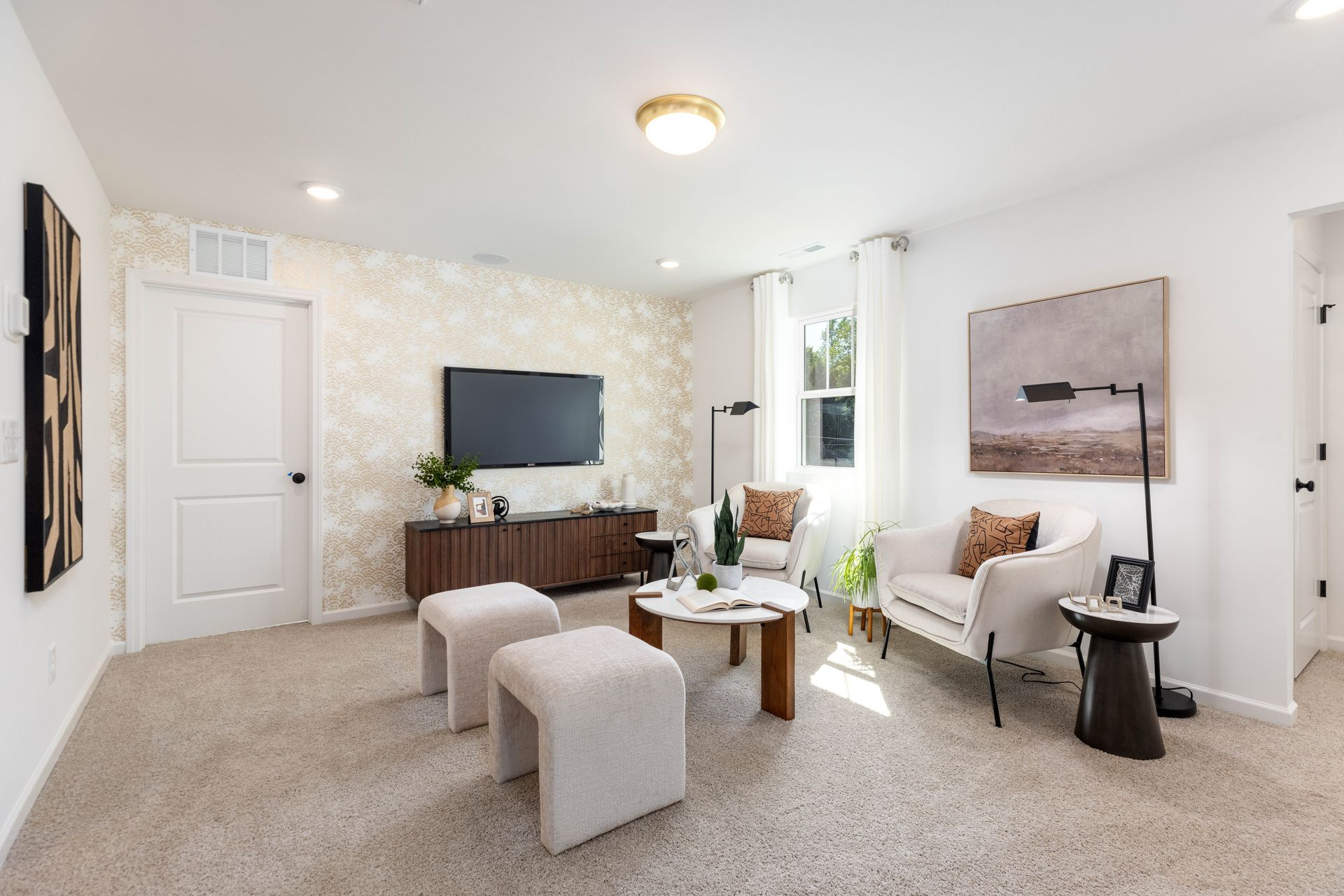 A living room with a couch , chairs , coffee table and television.