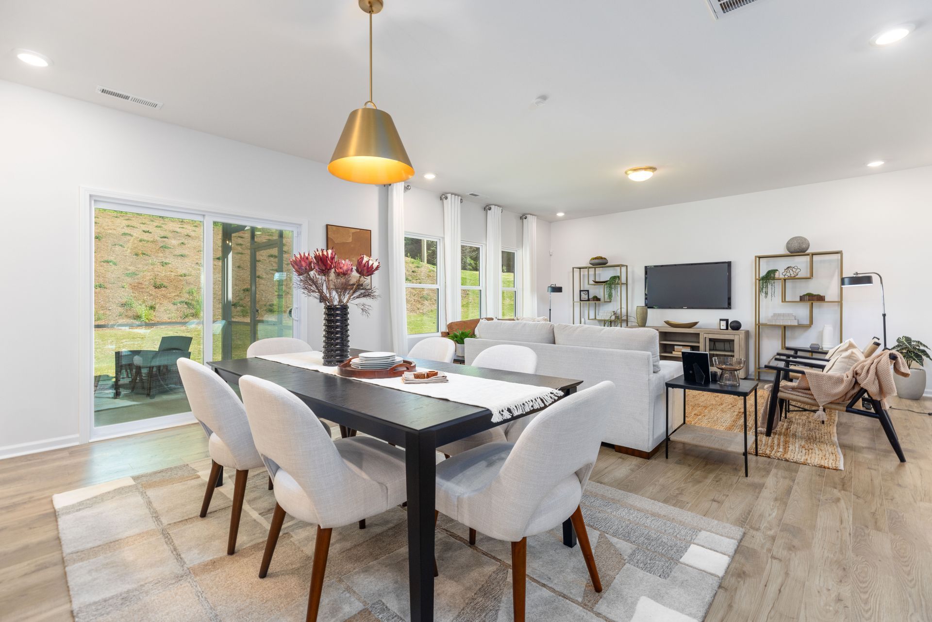 There is a dining table and chairs in the middle of the room.