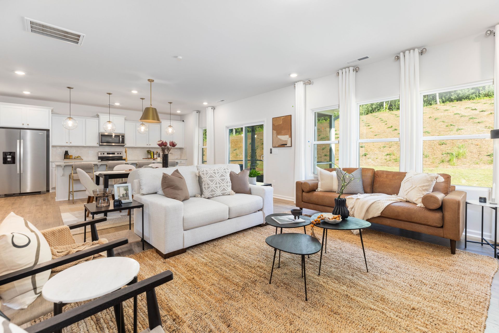 A living room filled with furniture and a rug.