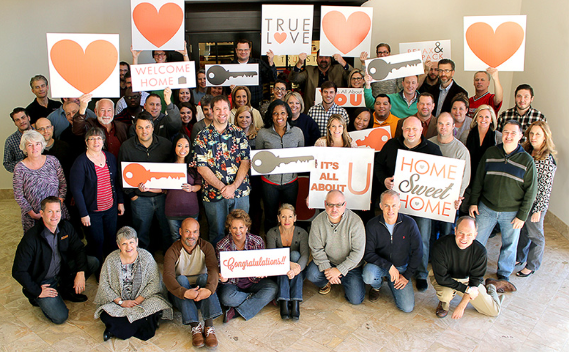 a group of people holding up signs that say home sweet home