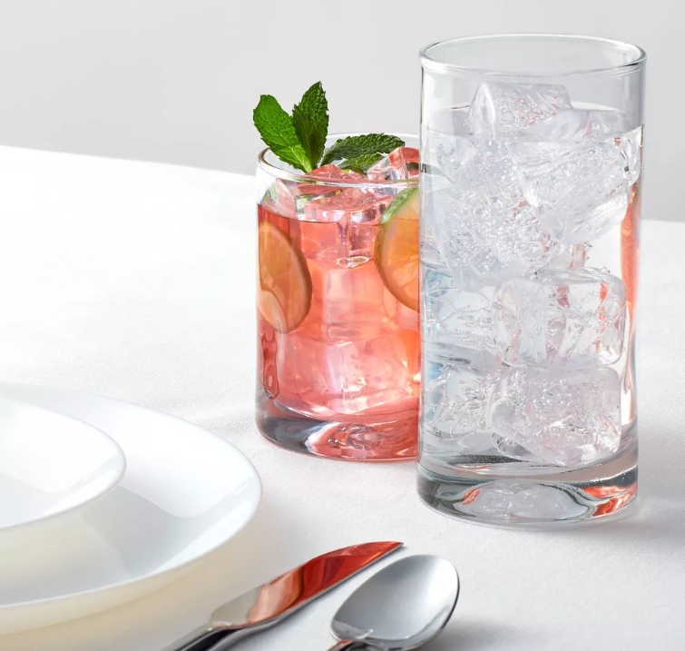 Two glasses of water with ice on a table